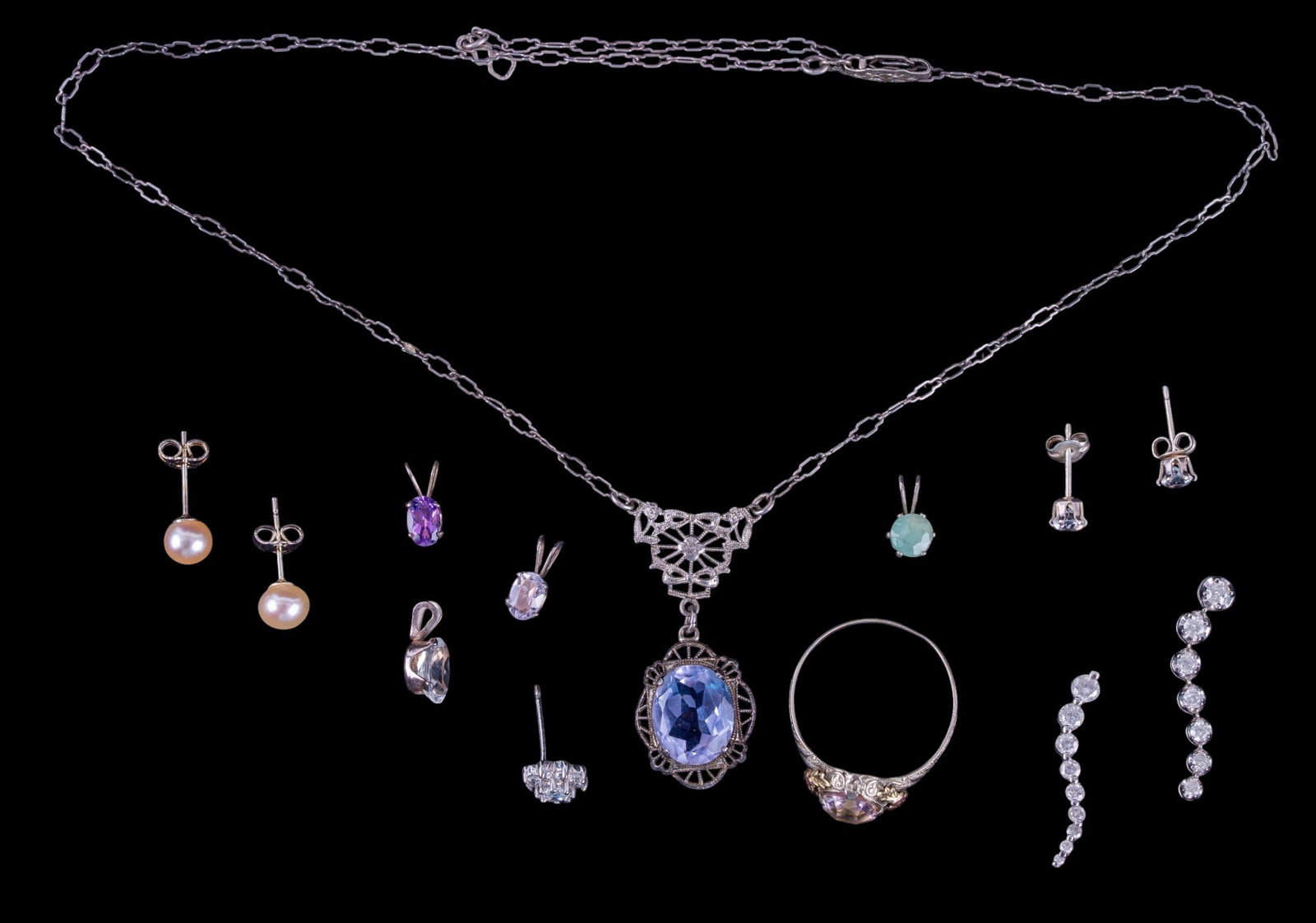 Sterling Silver Earring Collection and More: An Art Deco sterling necklace with facet cut stone pendant, small cut stone sterling pendants, ring with pink facet cut stone, size 10.5, freshwater pearls stud earrings, and two graduating cut stone 