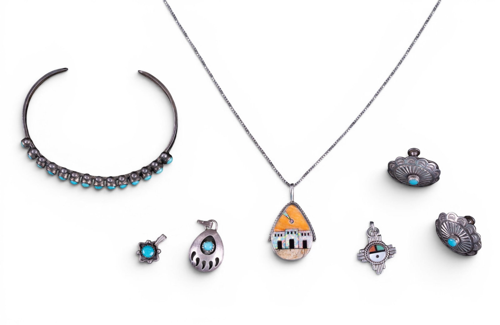 Sterling and Turquoise and Other Jewelry: A collection of sterling jewelry featuring pendants with turquoise cabochons, concho and turquoise earrings, an opal and stone inlay pendant marked 'Philippines' and a turquoise and unmarked silver cu