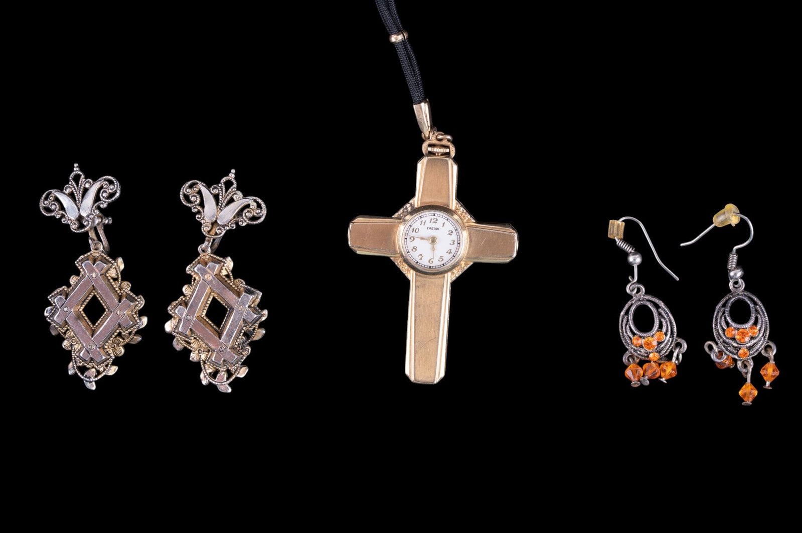 Victorian Earrings, Cross Watch: A pair of gold tone Victorian screw back picture frame style earrings, a pair of orange rhinestone silver tone French hook earrings, and a gold tone Cross watch featuring an Easton movement.
