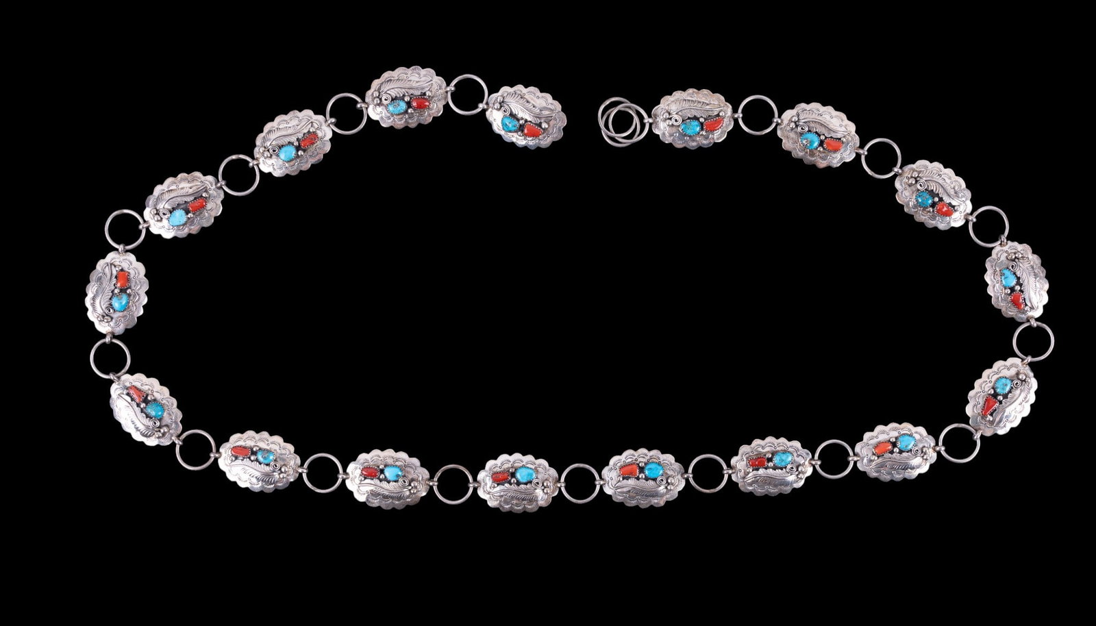Sterling Concho Belt: An artisan crafted sterling silver concho belt featuring turquoise and coral inlay, signed, measures approx. 43" L, total weight is approx. 5.1oz.