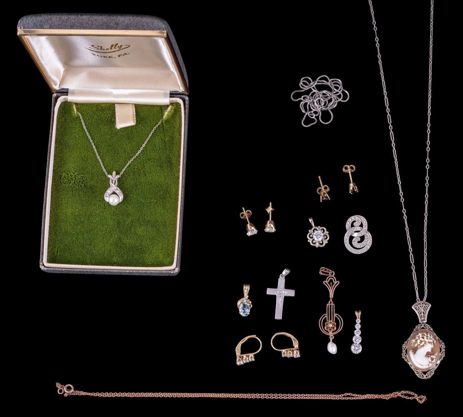 14K and 10K Jewelry: A collection of 14K jewelry pieces including a delicate filigree cameo necklace, approx. 8.5" on the drop, oval cut aquamarine/blue topaz pendant, graduated clear cut stone dangle earrings, clear