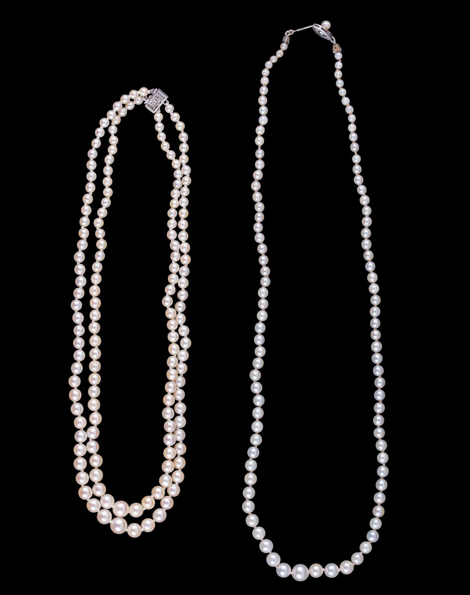 Graduated Pearl Necklaces: A multi strand graduated white pearl necklace with 10K white gold box clasp and a graduated white pearl necklace with a 10K white gold fish hook clasp. Longest measures approx. 9.5" on the drop.