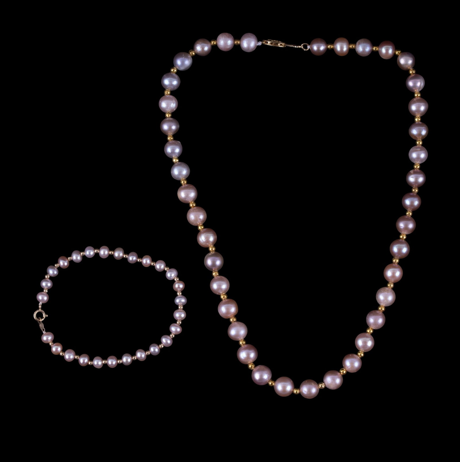 Pink & Purple Pearl Necklace & Bracelet, 14K Clasp: A pink and purple cultured pearl necklace with 14K gold clasp and beads, and a pink cultured pearl bracelet with 14K gold clasp and beads. Necklace measures approx. 8.5" on the drop.