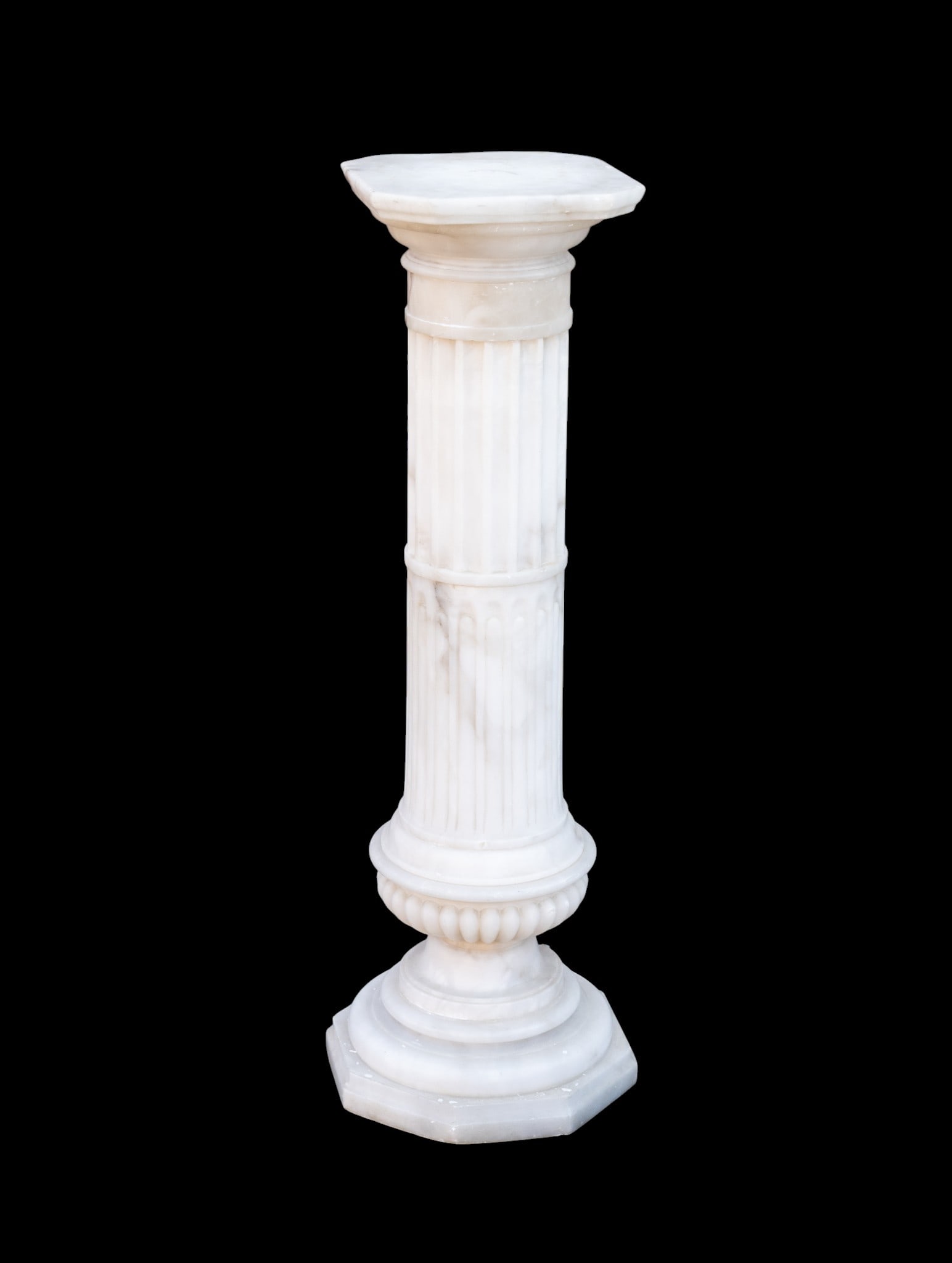 White Marble Pedestal Stand: White marble architectural pedestal with flat square top. Some loss to lower section as seen in photography. Measures approx. 43" H x 12" Square. Item is heavy, plan accordingly for pick up or special