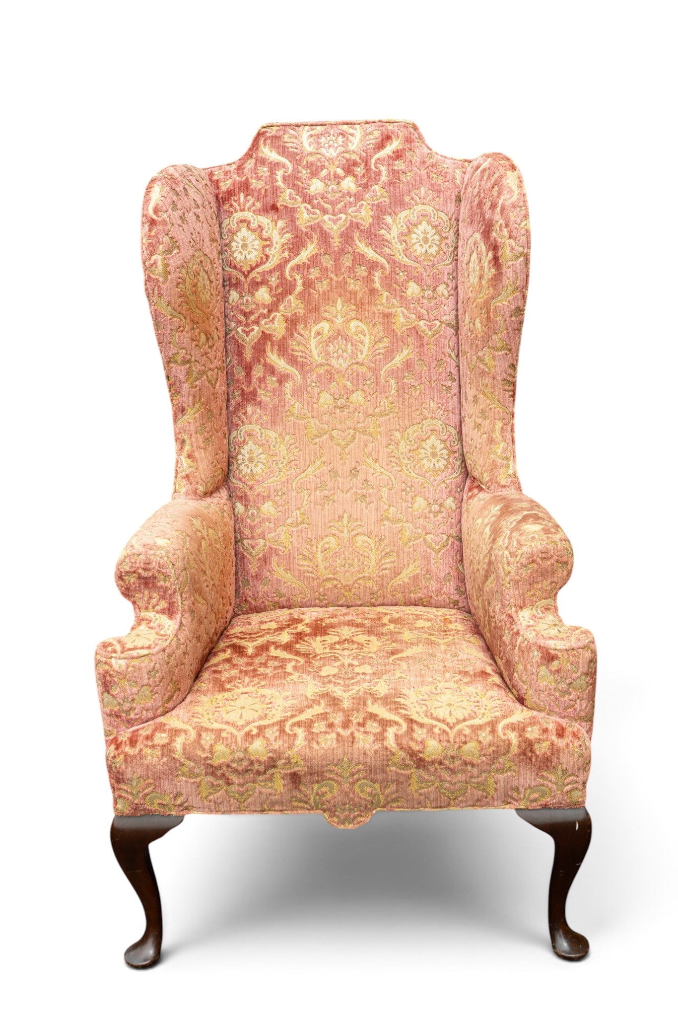 Early Velvet Embossed Wingback Armchair: An early pink velvet embossed Union made wingback armchair featuring mahogany legs and a International Union stamp on the bottom. Measures approx. 31" W x 30" D x 50" H. Special considerations should 