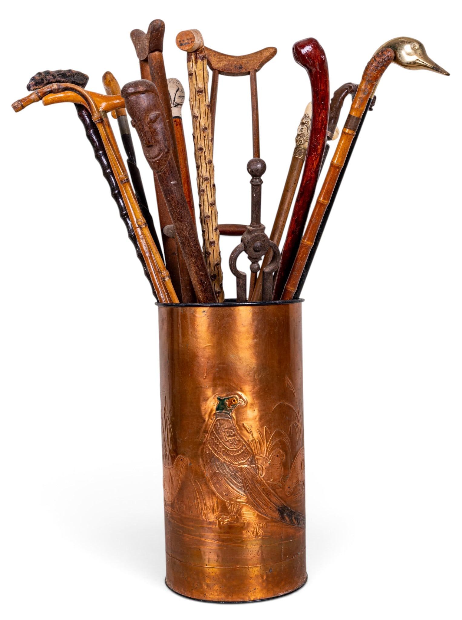 Embossed Umbrella Stand w/ Vintage/Antique Canes: Mid century embossed umbrella stand with pheasant design housing approx. 13 vintage to antique walking canes along with a pair of crutches and a fireplace tool. Stand measures approx. 18.25" H x