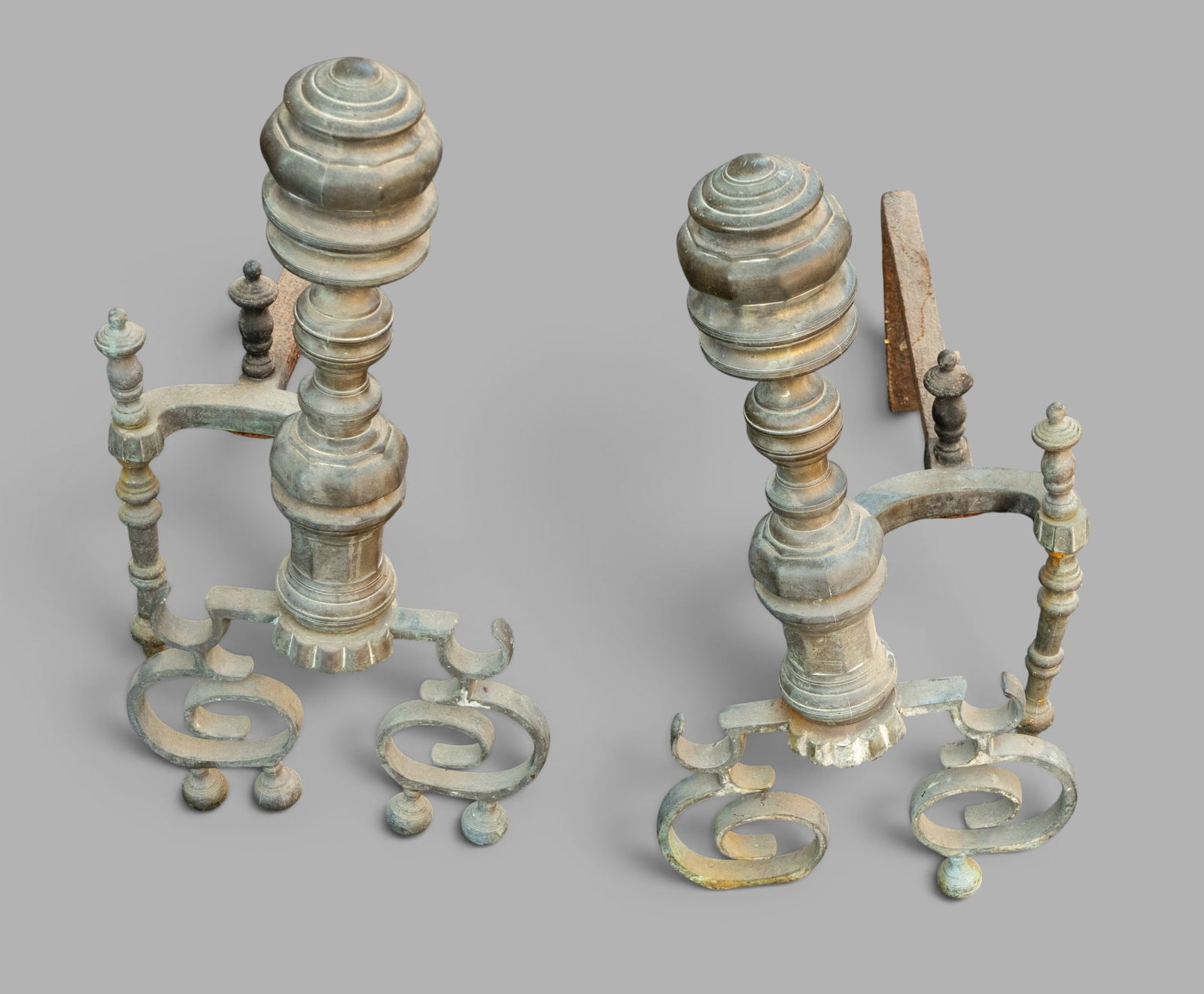 Pair of Early Andirons: Pair of late 19th/early 20th century andirons in the Connecticut River Valley style. Each measures approx. 24" H x 13" W x 25.5" D. One example missing 3 feet.