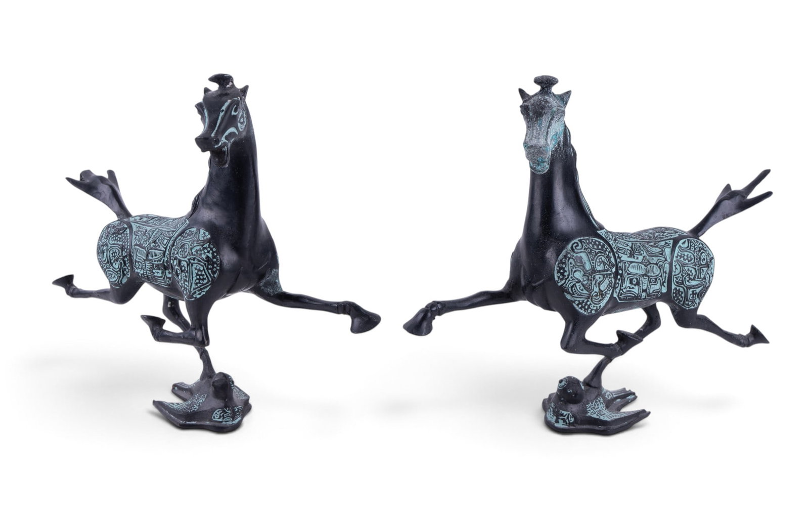 Pair of Chinese Flying Horse of Gansu Bookends: Pair of Chinese bronze bookends modeled as the Flying Horse of Gansu. Each is decorated with engraved scrolling and geometric motifs. Each measures approx. 9.5" W x 8" H.