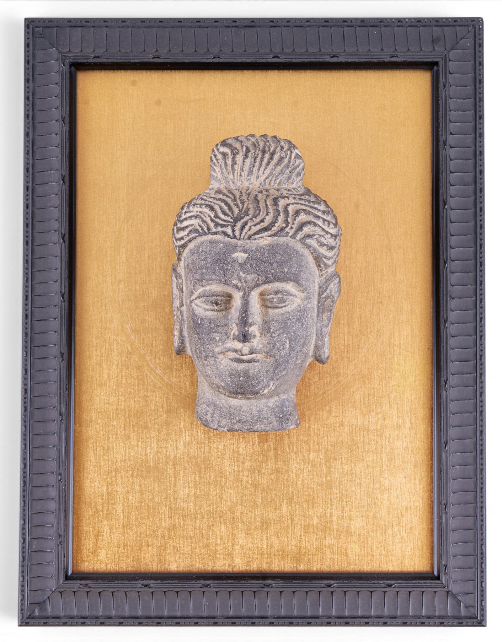 Stone Head of Buddha w/ Plaque: Carved gray stone head of Buddah featuring elongated earlobes, stylized hair, and serene facial features. Attributed to examples dating between the 2nd and 4th century CE. Measures approx. 5.5" H x