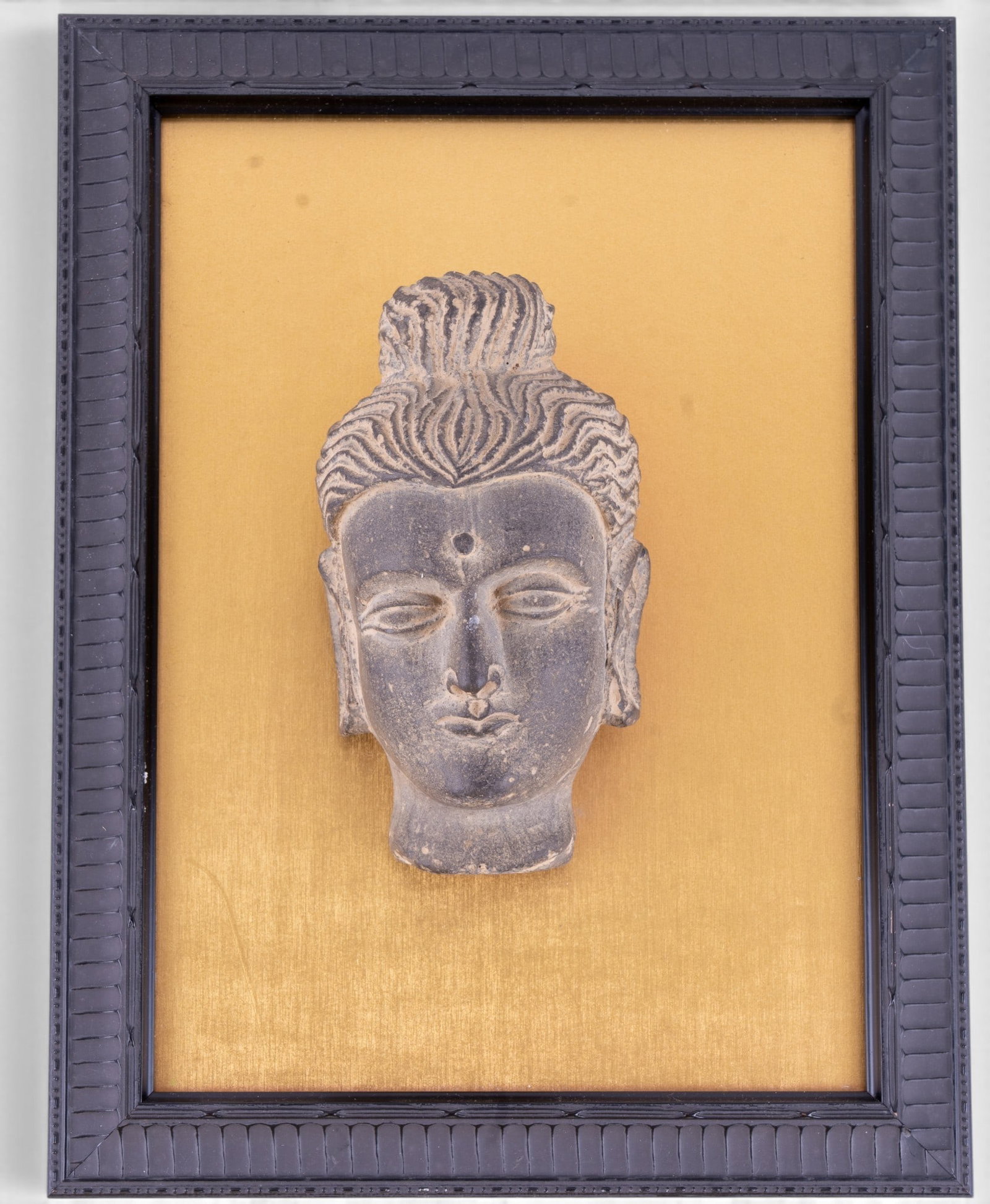Stone Head of Buddha w/ Plaque: Carved gray stone head of Buddah featuring elongated earlobes, stylized hair, and serene facial features. Attributed to examples dating between the 2nd and 4th century CE. Measures approx. 5.5" H x