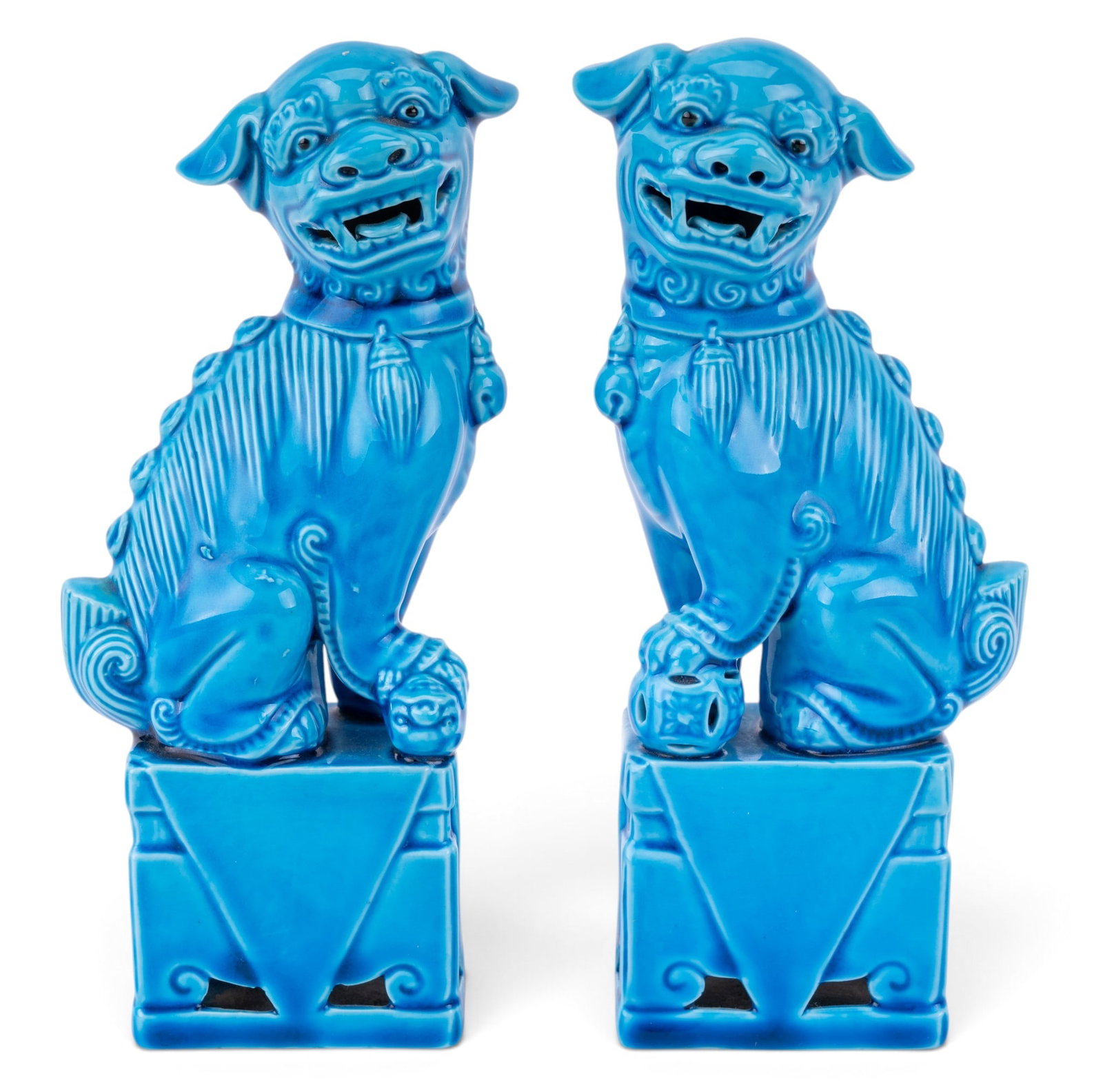 Turquoise Chinese Foo Dog Pair Bookends: A pair of porcelain Chinese foo dog bookends, hand dipped in turquoise color. One has an approx. 0.75" chip along inside edge at back of dog. Each item measures approx. 2.5"Lx1.5"Wx6.5"H.