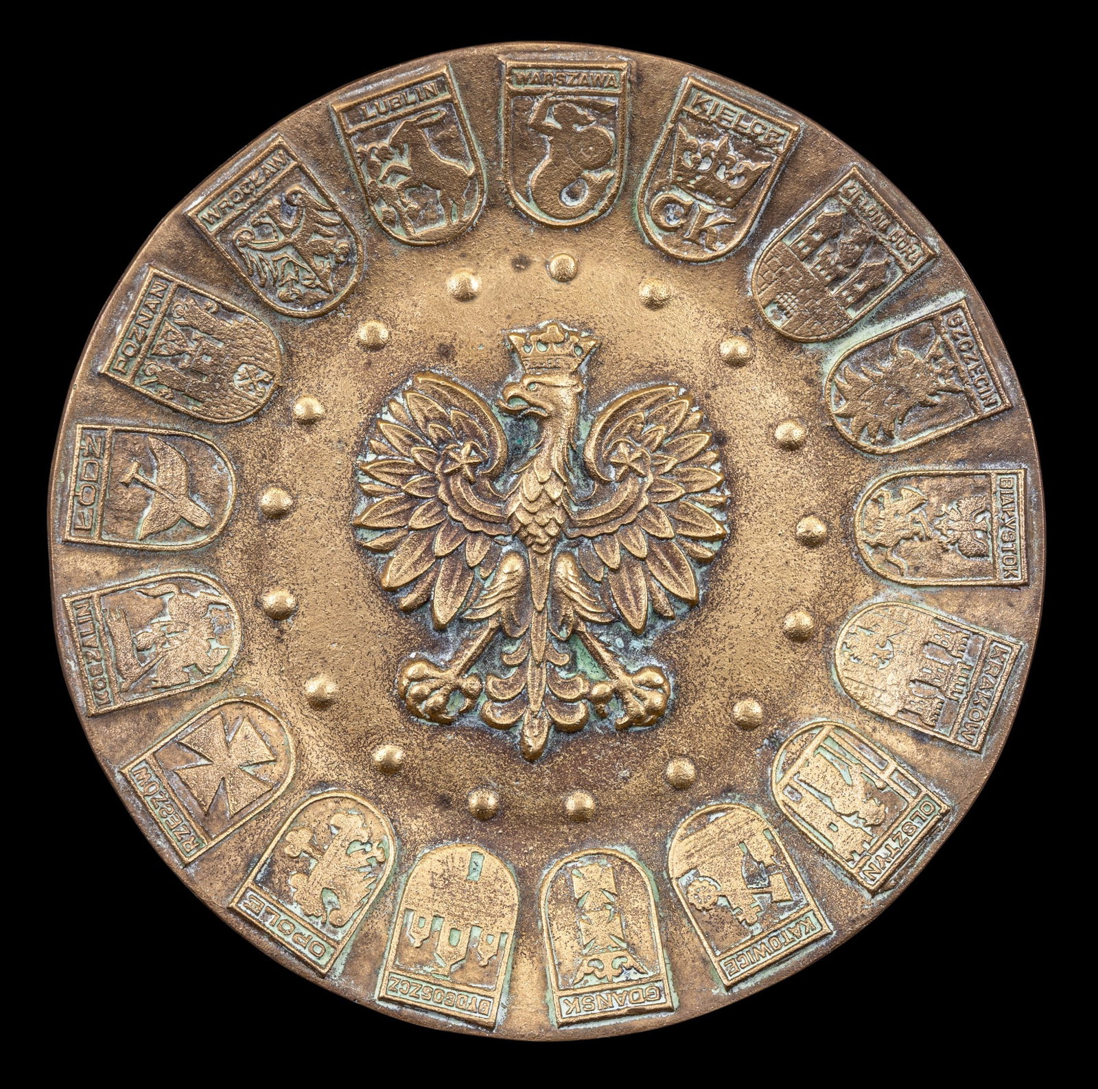 Polish White Eagle Relief Brass Plate: A Polish heavy brass plate depicting the White Eagle relief and crests from Polish cities around the rim, measures approx. 7" diam.