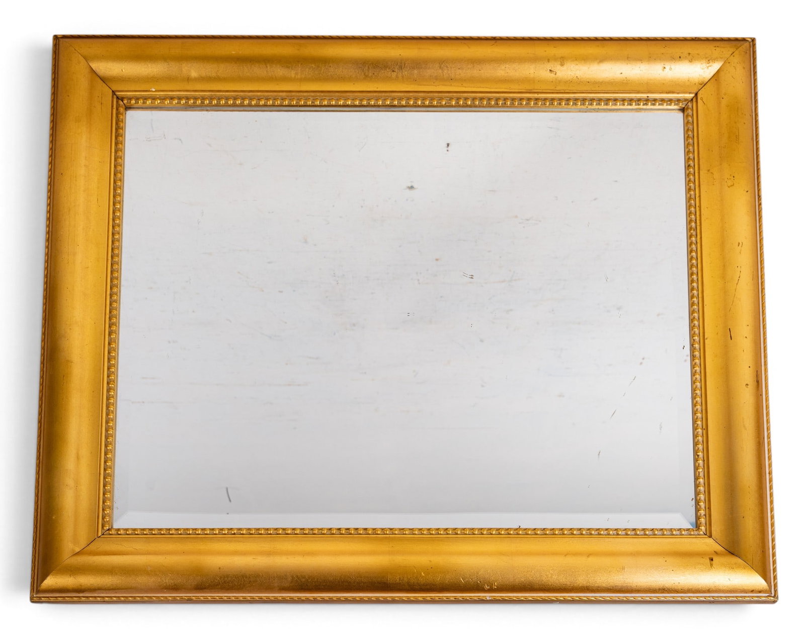 Decorative Gold Painted Wood Wall Mirror: A large decorative gold painted wood wall mirror featuring a beaded bevel in the frame and a beveled mirror pane. Measures approx. 34.5" W x 28.5" H.