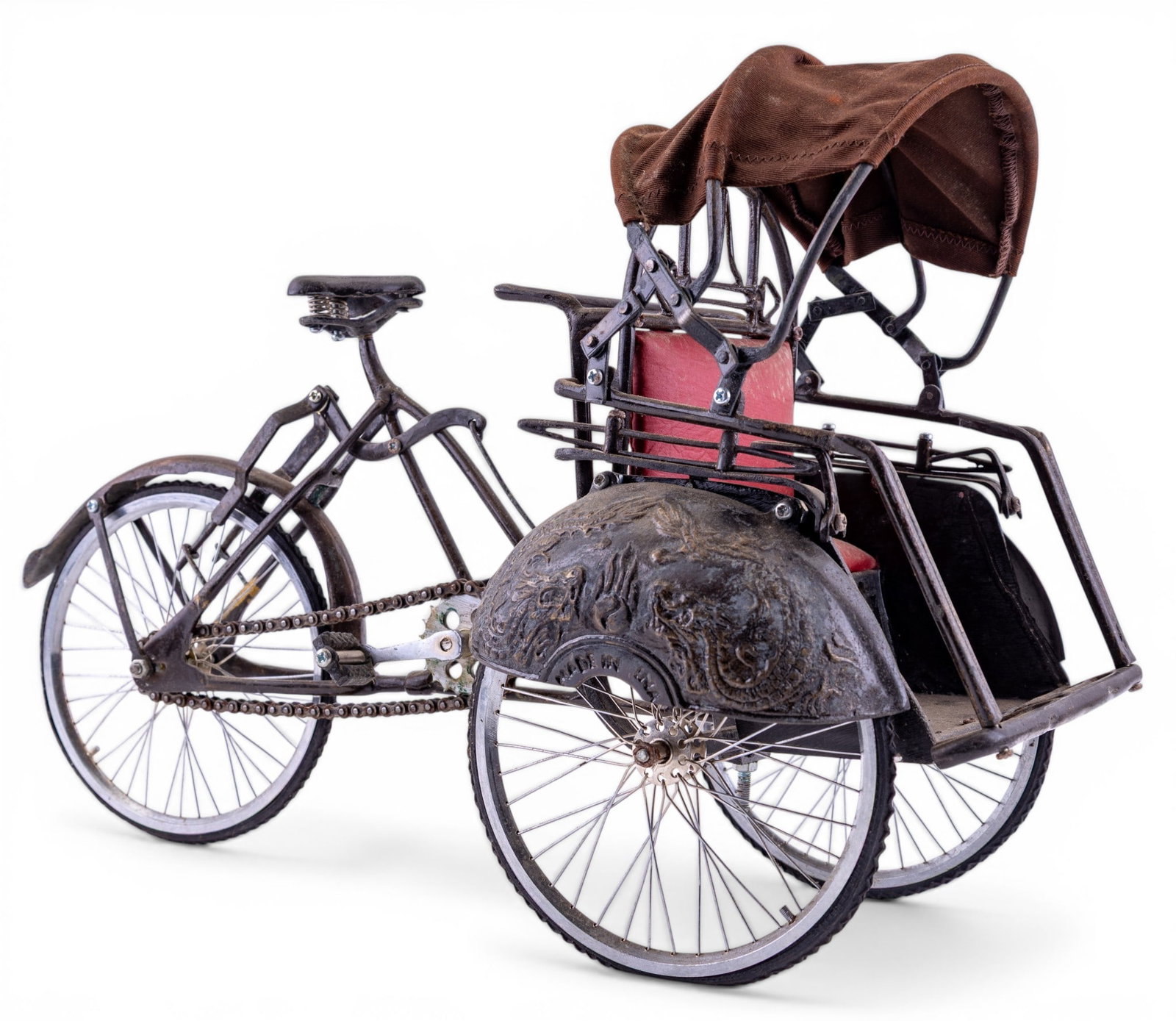 Decorative Miniature of Indonesian Becak: Decorative miniature of Indonesian Becak, commonly known as cycle rickshaw. Item is constructed from metal, with working cycling mechanism, and canopy. Seat fabric appears to be pleather, and canopy