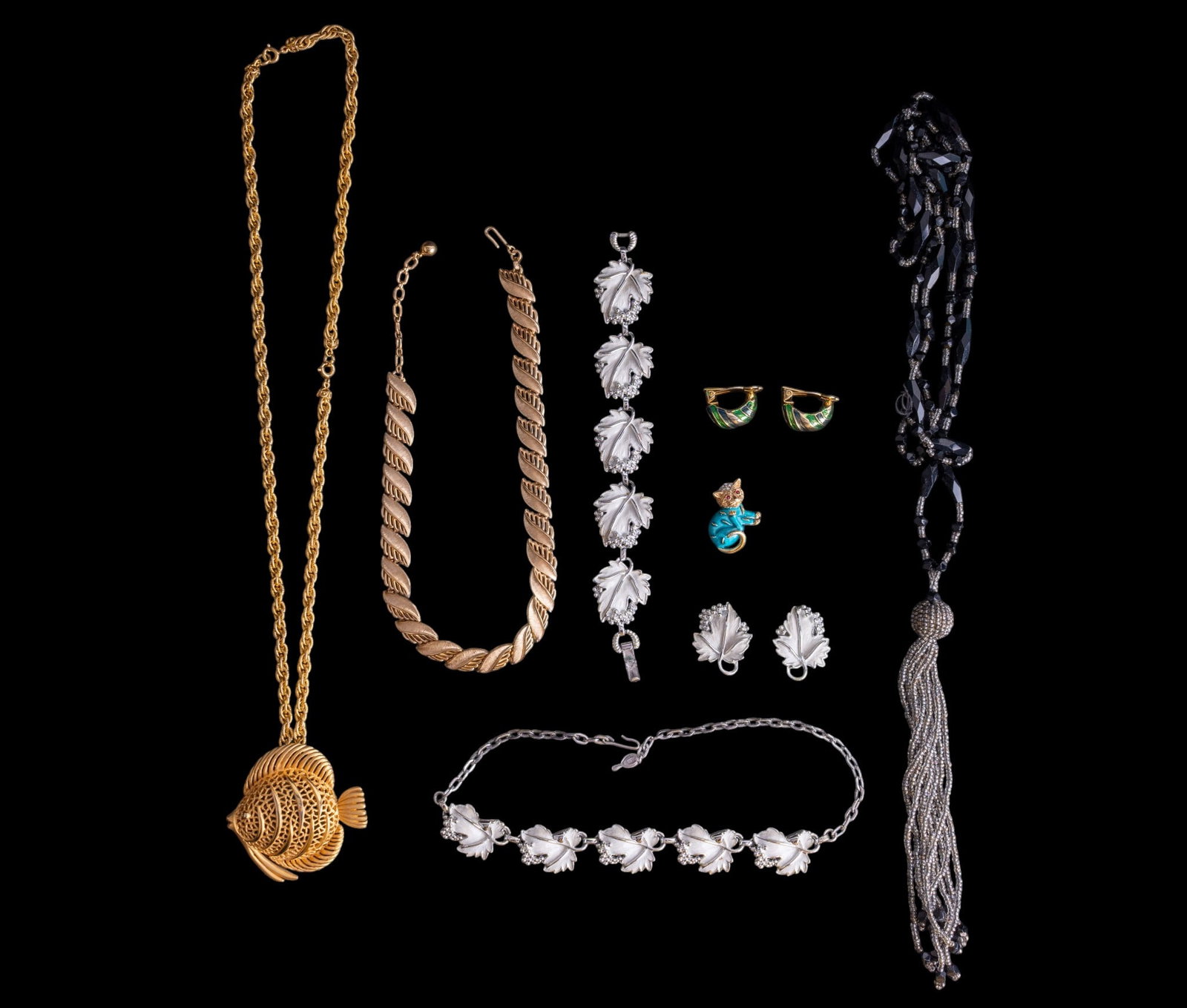 Trifari Cat Brooch and Estate Jewelry: Blue enamel Trifari cat/kitten brooch, goldstone Trifari necklace, Sarah Coventry necklace & earrings, antique glass necklace, and a gold tone fish necklace.