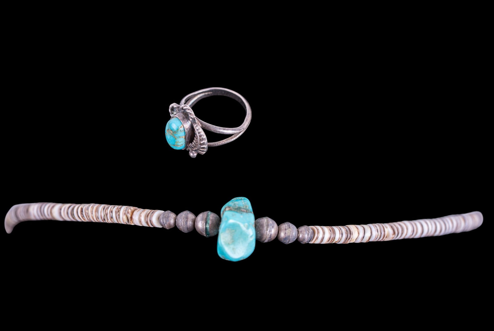 Native and Southwest Silver Jewelry: Shell necklace with central turquoise pendant and silver bead work, and a silver hand made vintage ring set with turquoise.