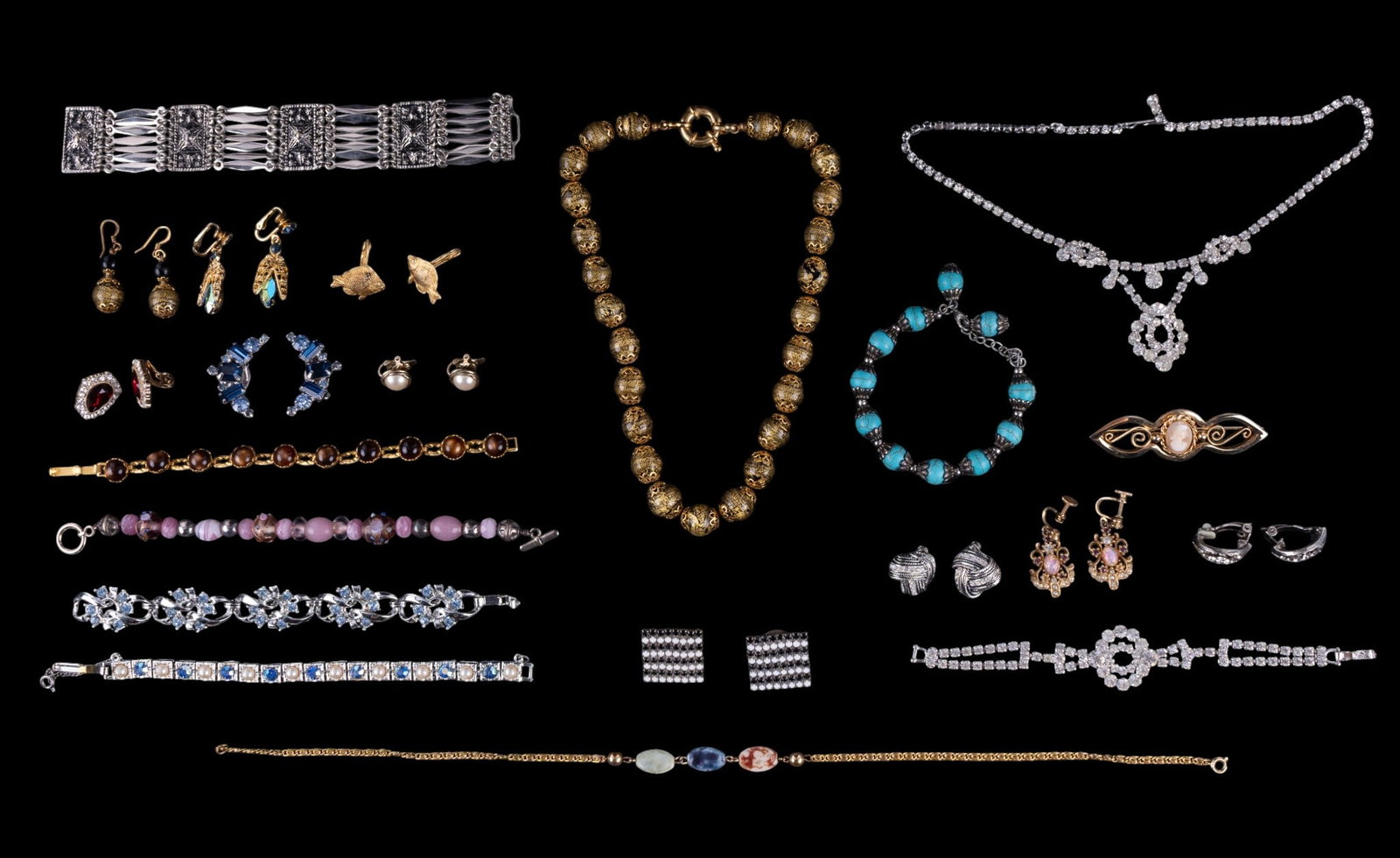 Taxco Sterling and Other Bracelets: A collection of vintage costume bracelets, rhinestone earrings, vintage rhinestone necklace and bracelet set, a vintage cameo style bar brooch, and a Taxco Mexico sterling silver panel bracelet. Brace