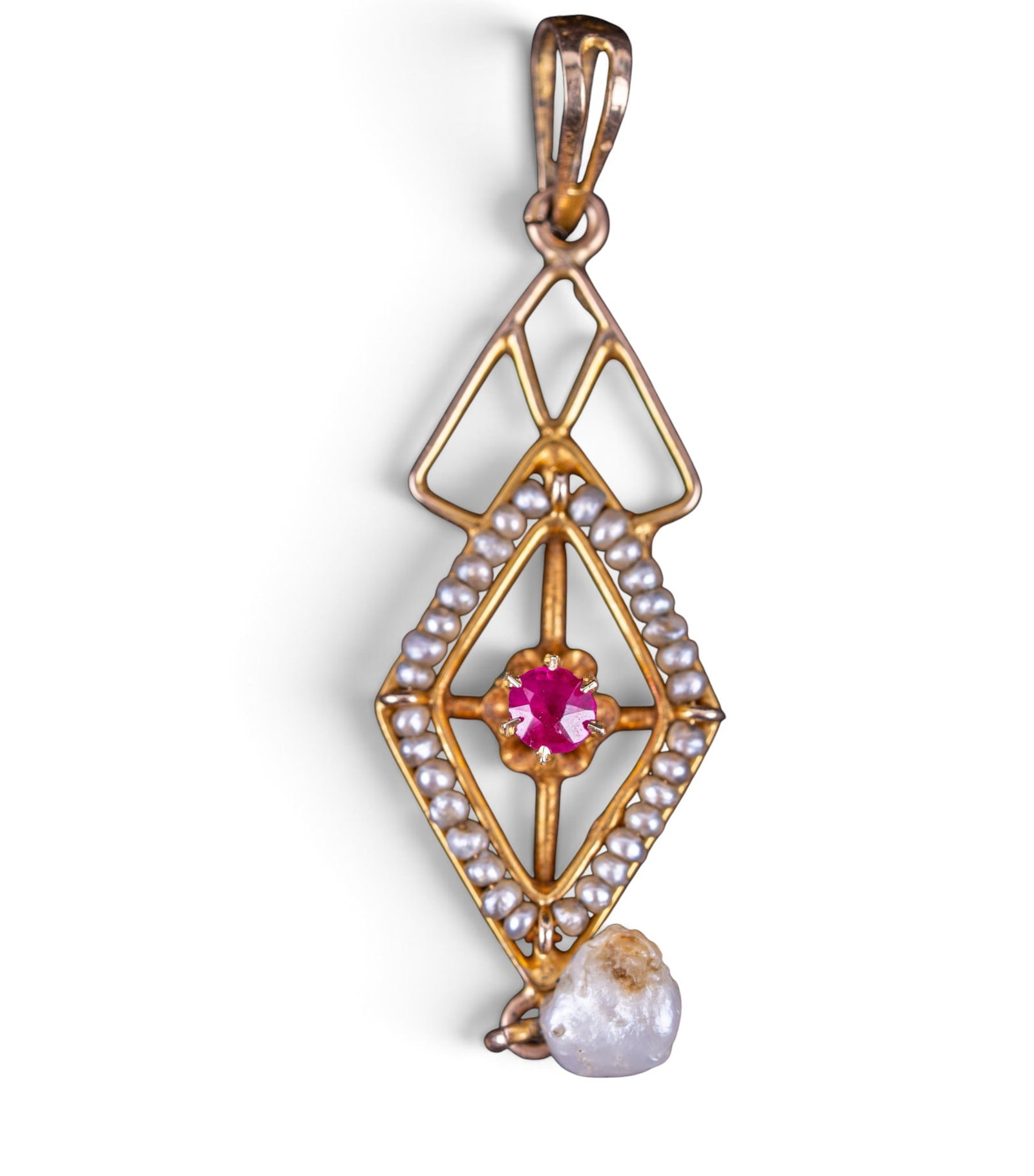 10K Gold Victorian Pendant: A 10K gold Victorian pendant featuring a faux freshwater pearl, seed pearls, and facet cut ruby colored stone center. Total weight is approx. 0.6dwt.