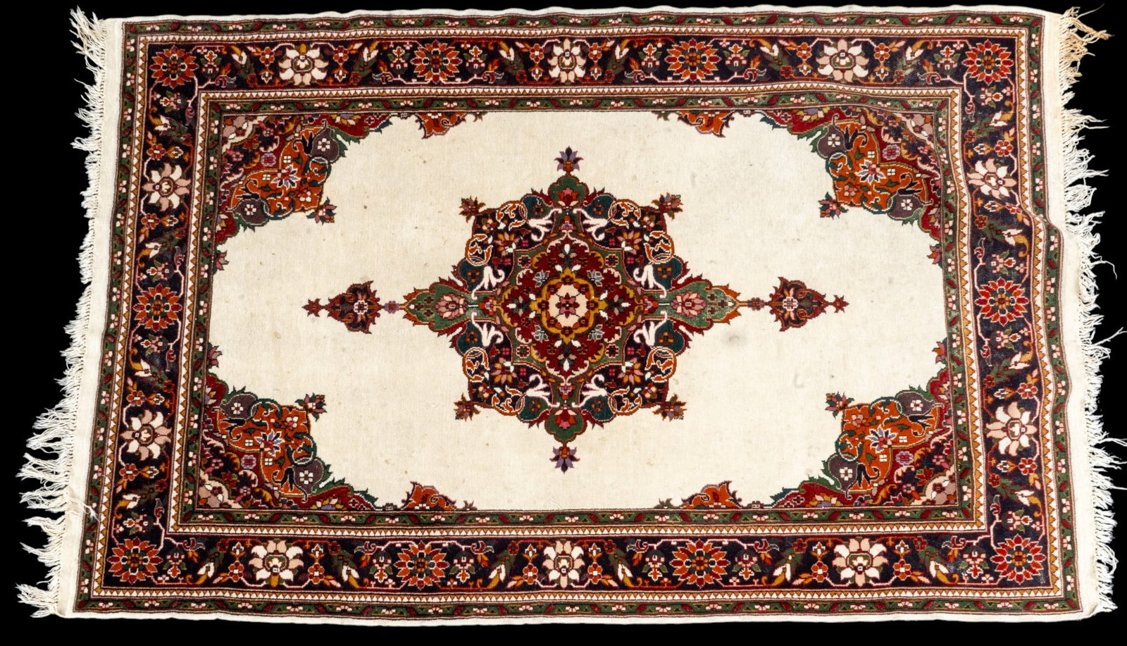 Persian Finely Woven Carpet: Finely woven Persian carpet with red, green, and cream tones, and central floral medallion. Measures approx. 4' x 6'3".