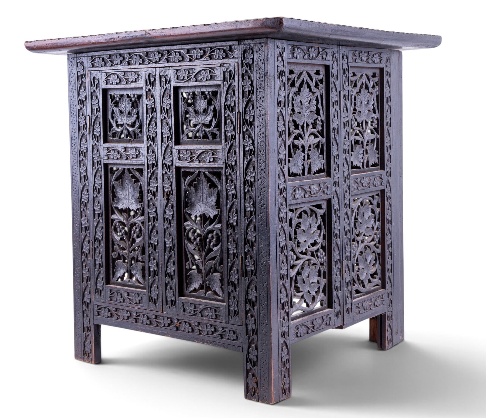 Anglo-Indian Carved Hardwood Folding Side Table: An antique Anglo-Indian intricately carved and pierced folding hardwood storage side table with doors. The frame can fold flat and the top lifts off, all together measures approx. 17.75" W x 17.5" D x