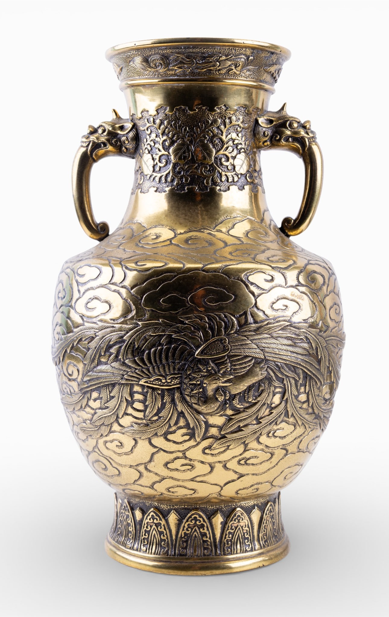 Antique Signed Vase Dragon and Phoenix Relief: Antique heavy brass vase of baluster form, decorated in high relief with scrolling clouds, phoenix bird in flight, relief dragon on each side of rim and other foliate motifs. Vase features a pair of o