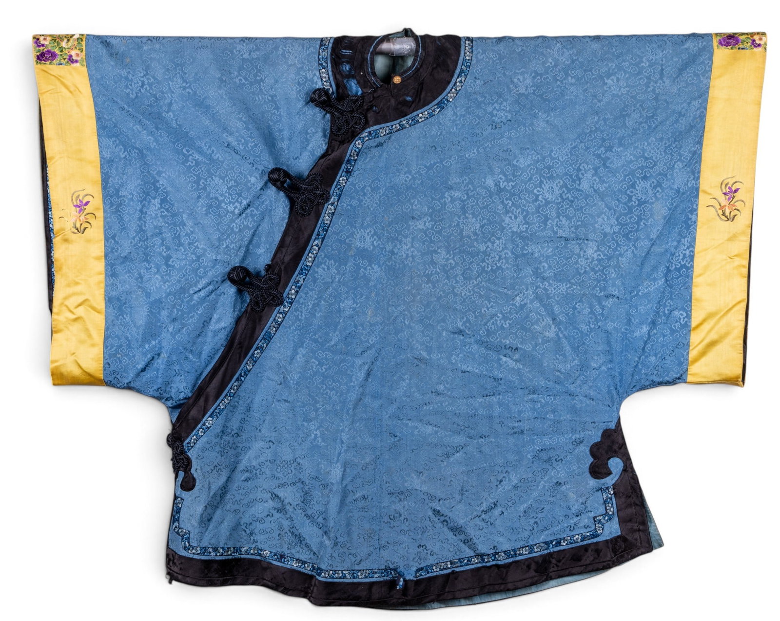 Chinese Silk Brocade Robe/ Jacket: Chinese silk brocade garment in pale blue with a woven floral pattern, knotted frog closures, and bright yellow sleeve panels with floral motifs. Measures approx. 48" from sleeve end to sleeve end and