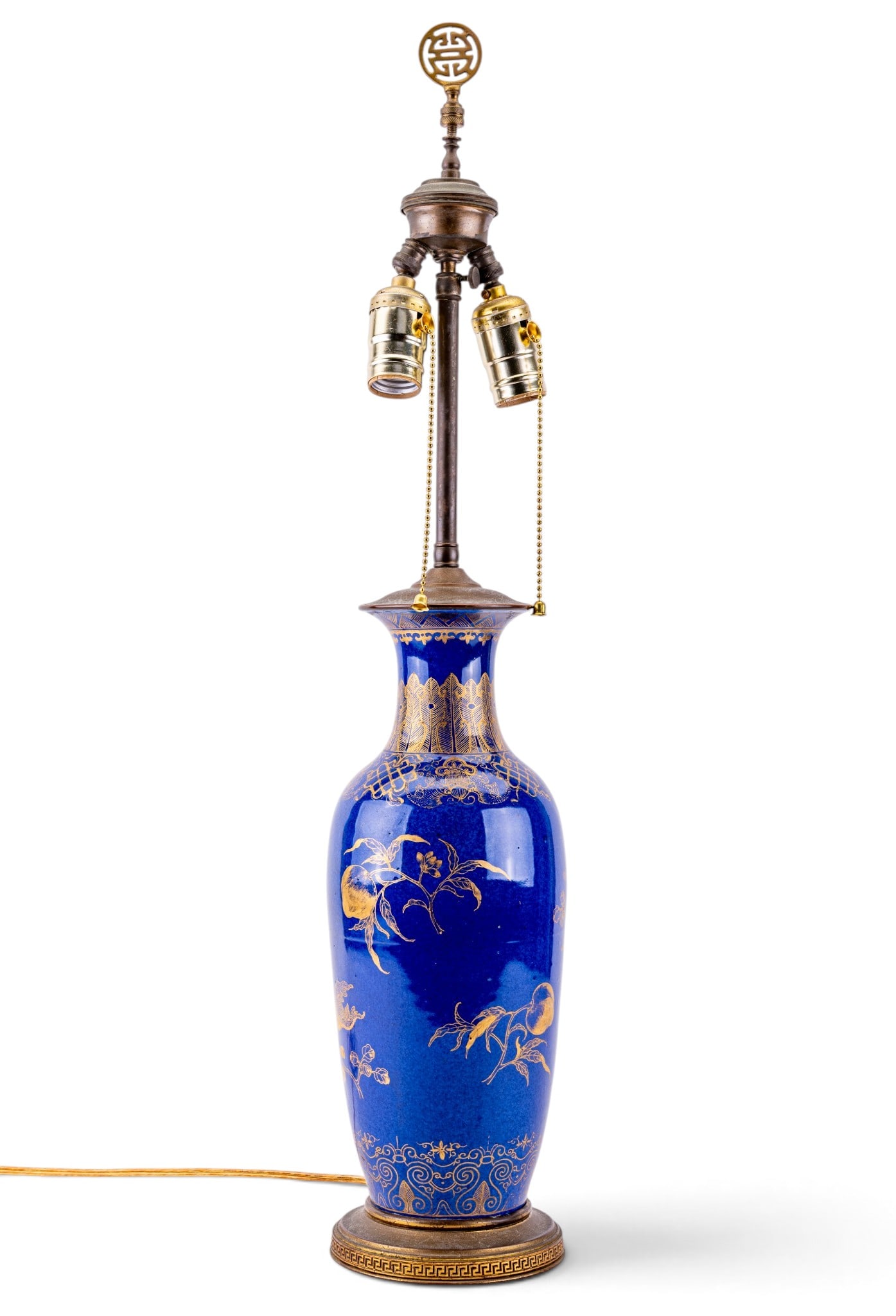 Chinese Blue & Gilt Porcelain Vase Lamp: Chinese porcelain vase lamp featuring a cobalt blue glaze with gilt floral, fruit, and scrolling decorative motifs. Mounted on metal base with Greek key border. Fitted with a double-socket assembly. M