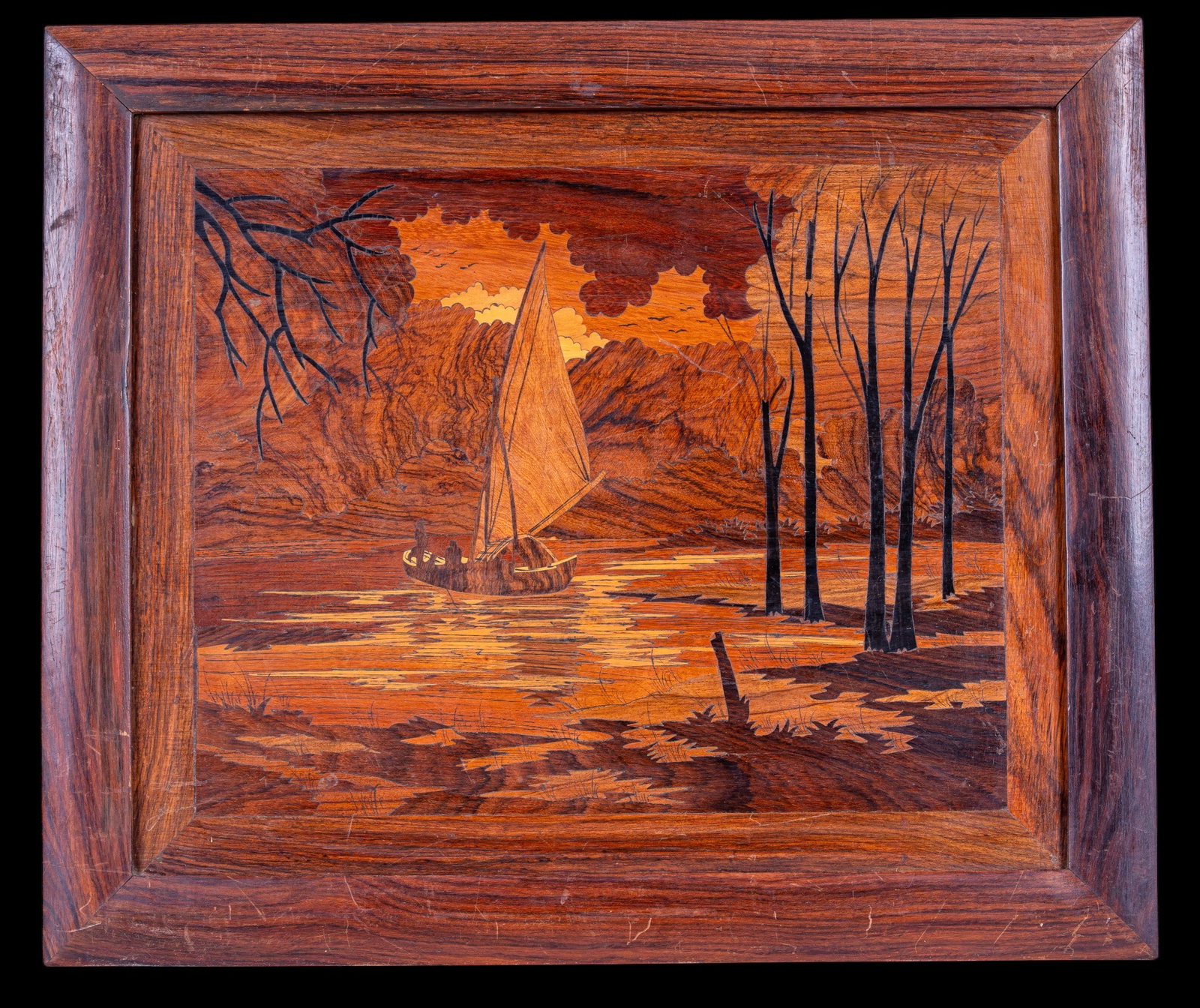 Marquetry Wood Art: A framed Marquetry wood inlay wall art panel depicting a sailboat on a lake, measures approx. 17.75" H x 21" W.