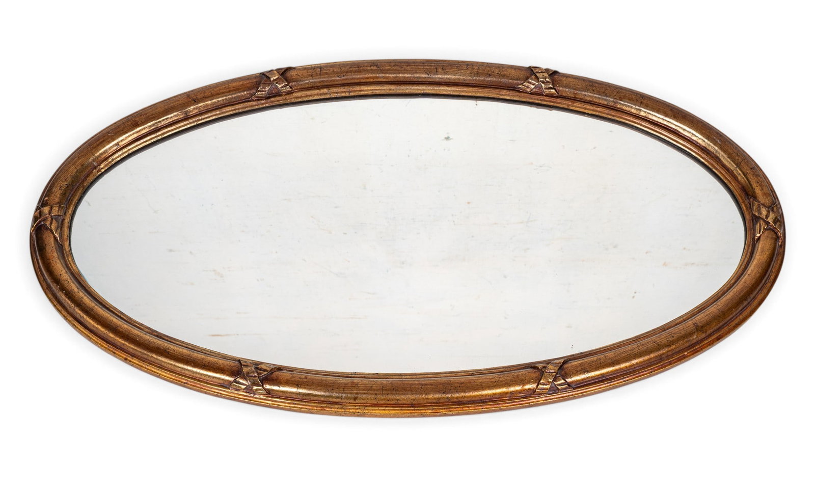 Vintage Oval Decorator Mirror: A vintage oval carved and gold painted wood decorator mirror featuring ribbon X's, measures approx. 43" H x 22" W.
