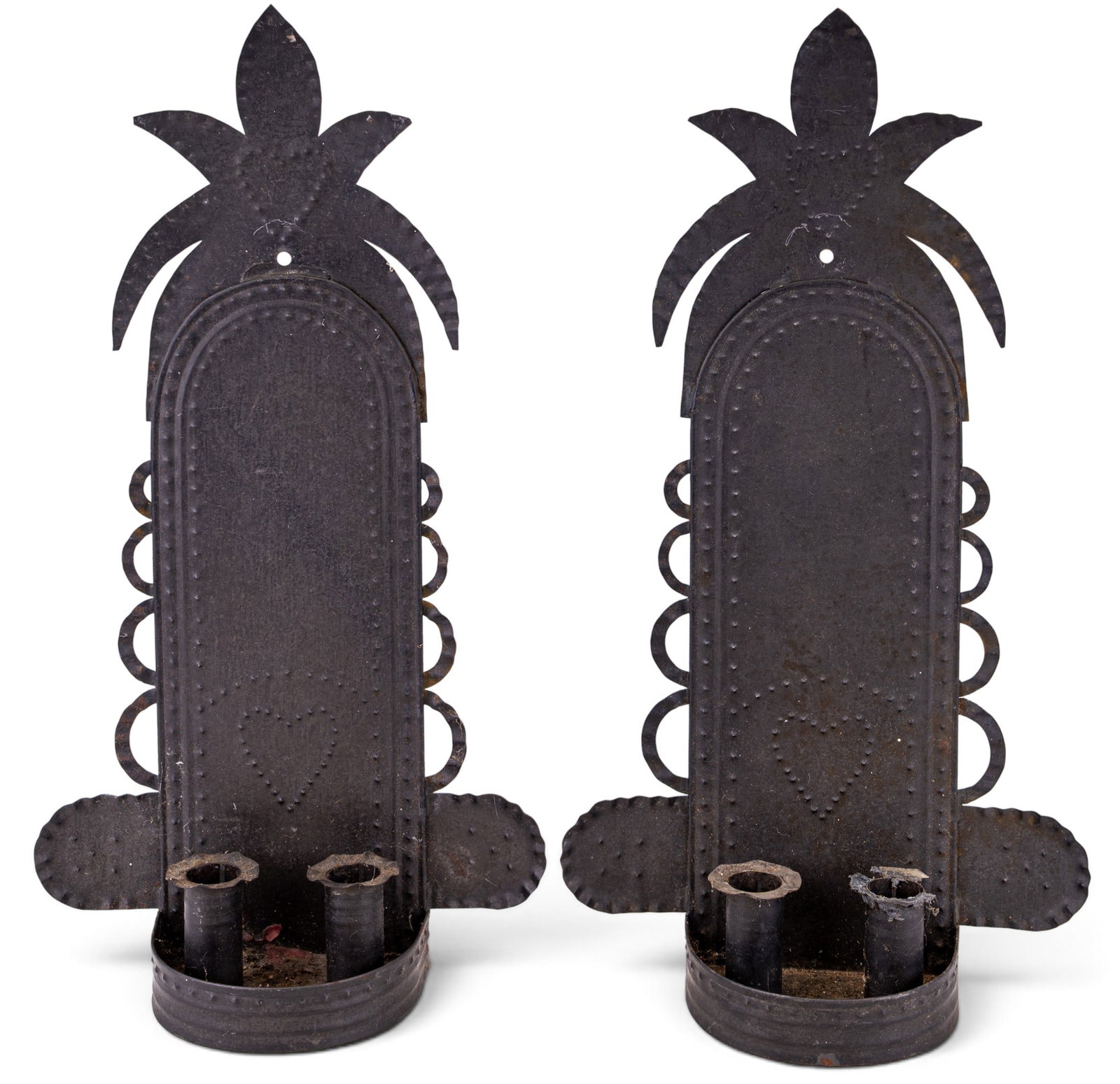Pair of Punched Tin Wall Sconces: Pair of punched tin wall sconces, each with backplate featuring pierced heart and geometric decoration with stylized pineapple crest. Each bears a handwritten inscription to the reverse reading