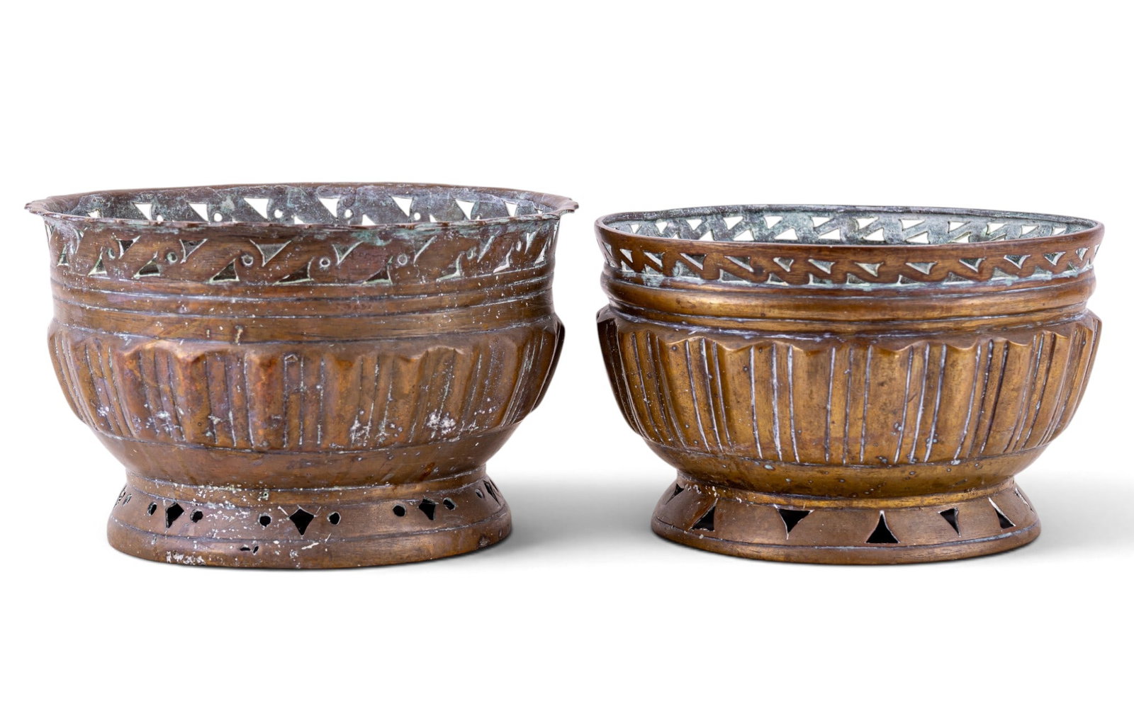 Pair of Brass Pierced & Fluted Jardinieres: Companion pair of brass jardinieres having pierced geometric galleries, fluted bowl-form bodies, and pierced pedestal bases. One example with scalloped rim. One example slightly larger, measuring appr