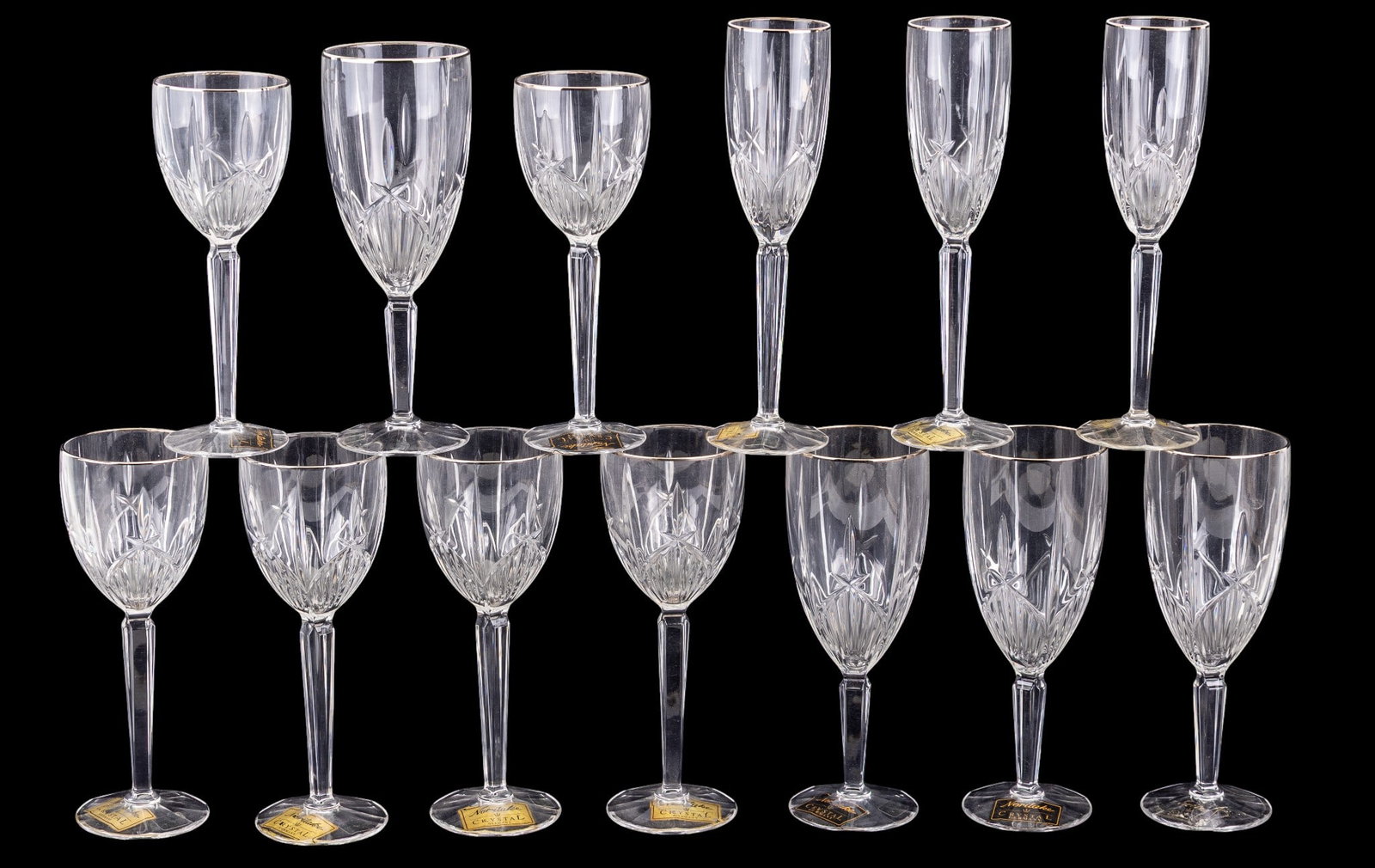 15 Noritake Silver Rimmed Crystal Stemware: A collection of silver rimmed cut crystal Noritake stemware including 4 iced tea, 3 flute, 4 wine, and 4 water. original labels on most with Platin model.