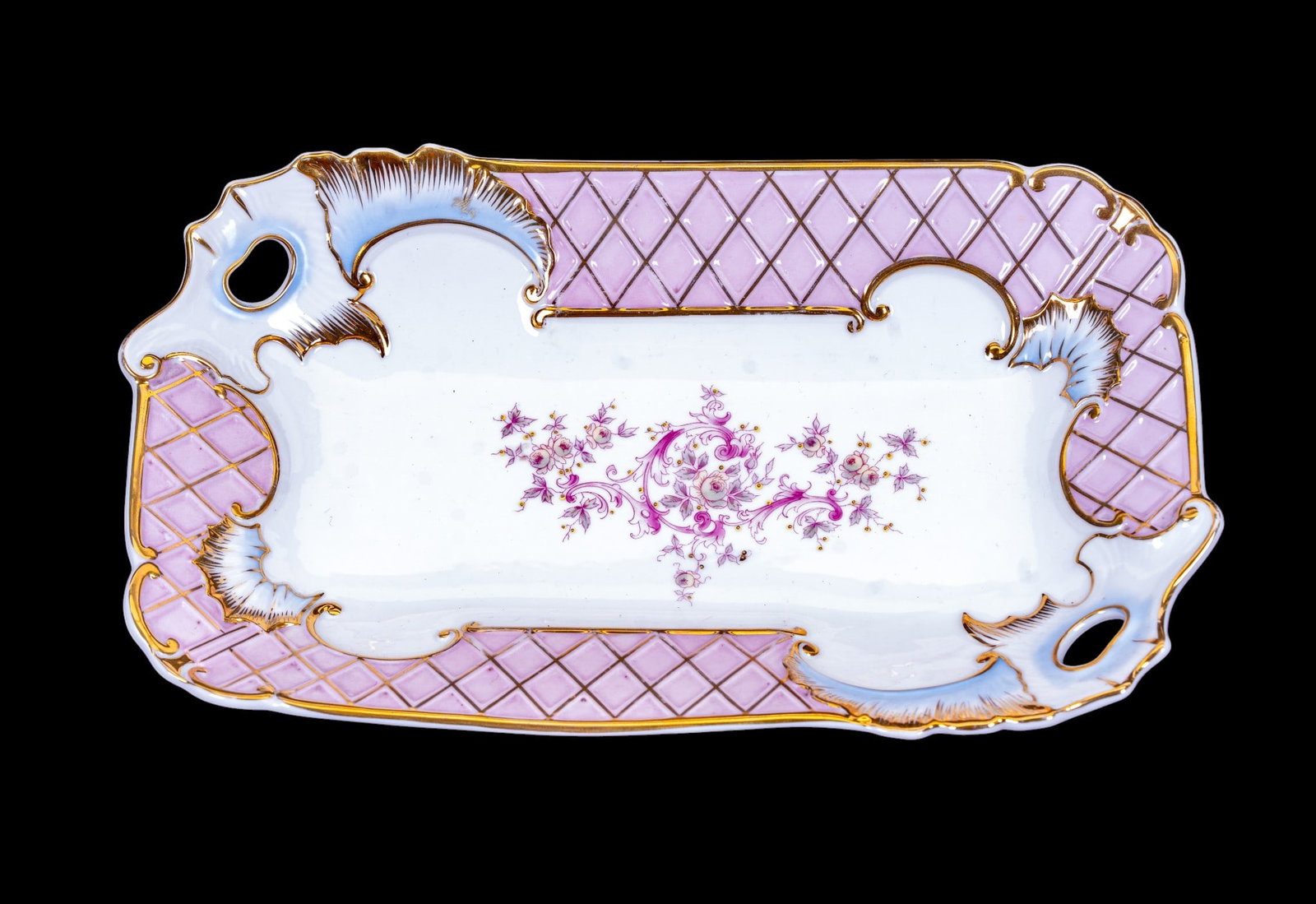 German Hand-Painted/Gilt Pink Lace Porcelain Tray: Porcelain tray decorated with pink lace and gold gilt trim and shell/floral design. Two opposite corners feature ornate molded thumbhole handles. Center features raised golden-colored accent dots. Can