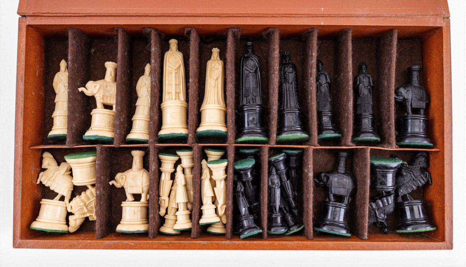 Vintage Midcentury Chess Set in Felt-Lined Case: Mid-20th century figural 32-playing piece chess set in its wooden presentation and storage case. Features dual-row partitioned divider system lined with protective brown felt/ flocking. Chess pieces