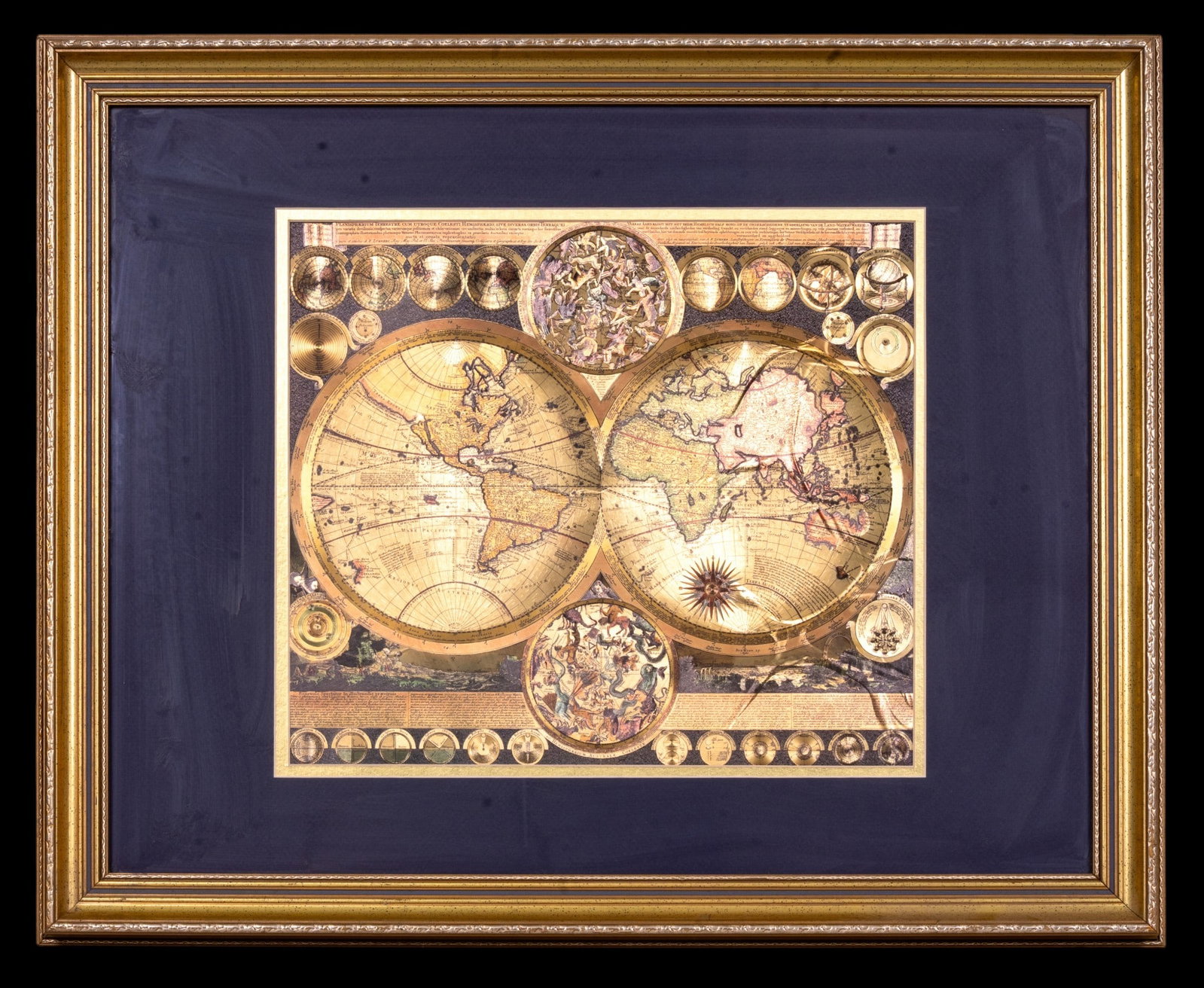 Framed Gold Foil Print of Planisphaerium Terrestre: A framed gold foil print depicting the Planisphaerium Terrestre double hemisphere world map originally done by Dutch cartographer Peter Schenk the Elder (1645-1715). Frame measures approx. 25.5" H x