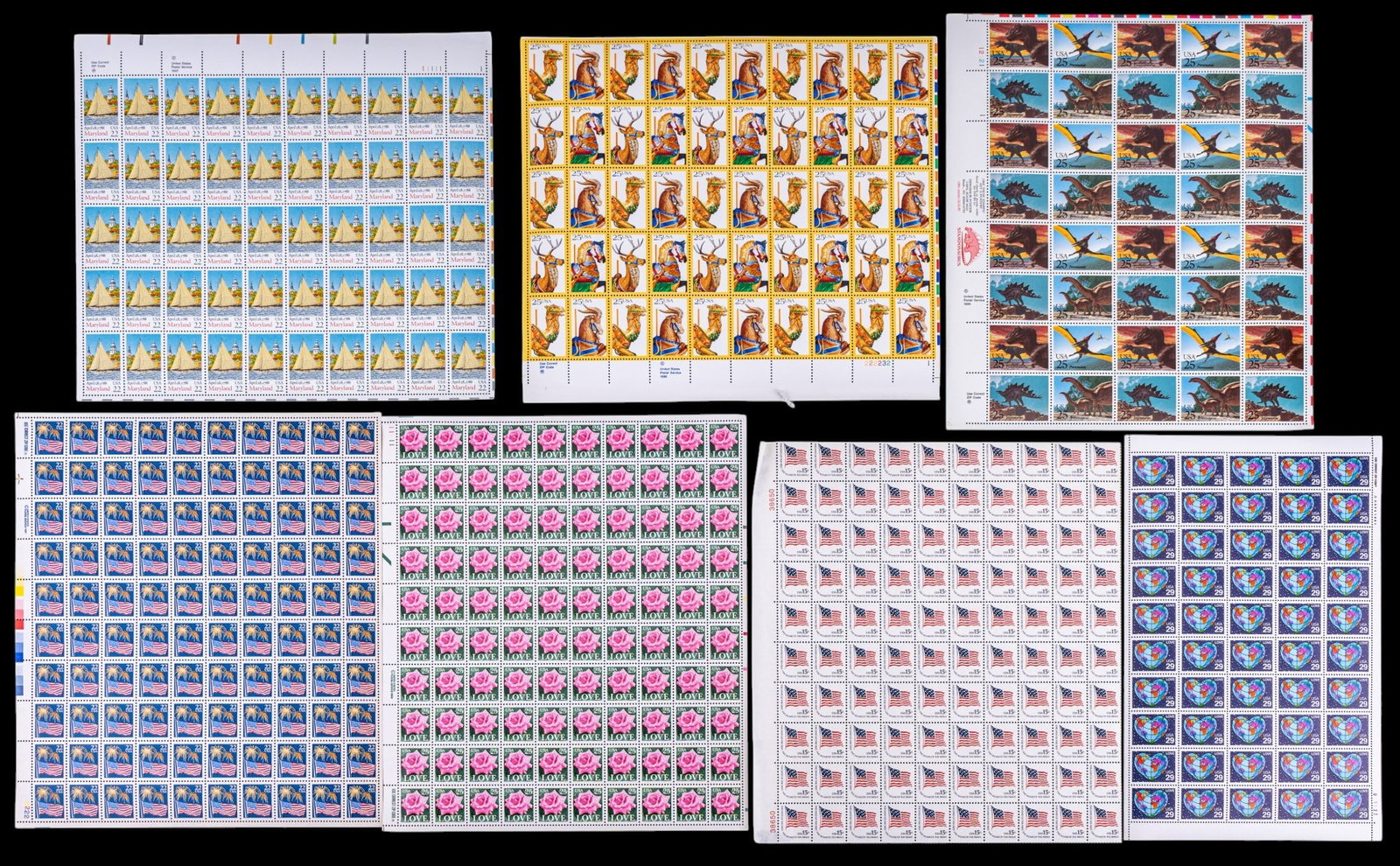 Collectible U.S. Postage Sheets: A collection of vintage U.S. Postage sheets including themes such as dinosaurs, Maryland, carousel, and others in denominations of 15 cents, 22 cents, 25 cents, and 29 cents.