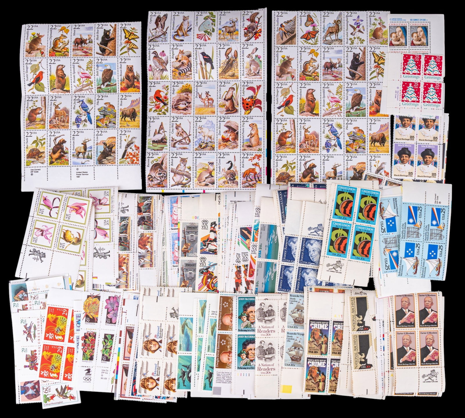 Collectible U.S. Postage Stamps: A alrge assortment of collectible U.S. postage stamps in 4-square sheets including denominations such as 20 cents, 22 cents, 25 cents, and 29 cents.