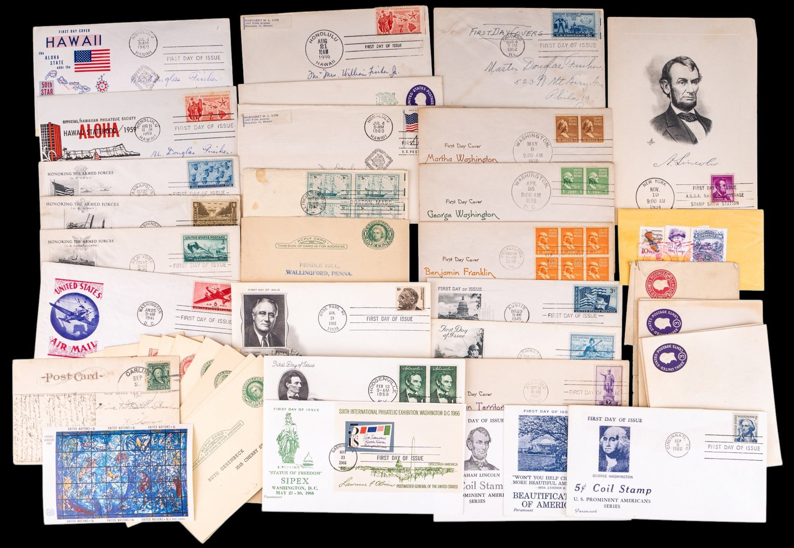 Early U.S. Postage: A collection of early U.S. postage including first day issue cards, post cards with canceled postage, loose stamps, block sheets, and pre-stamped envelopes.