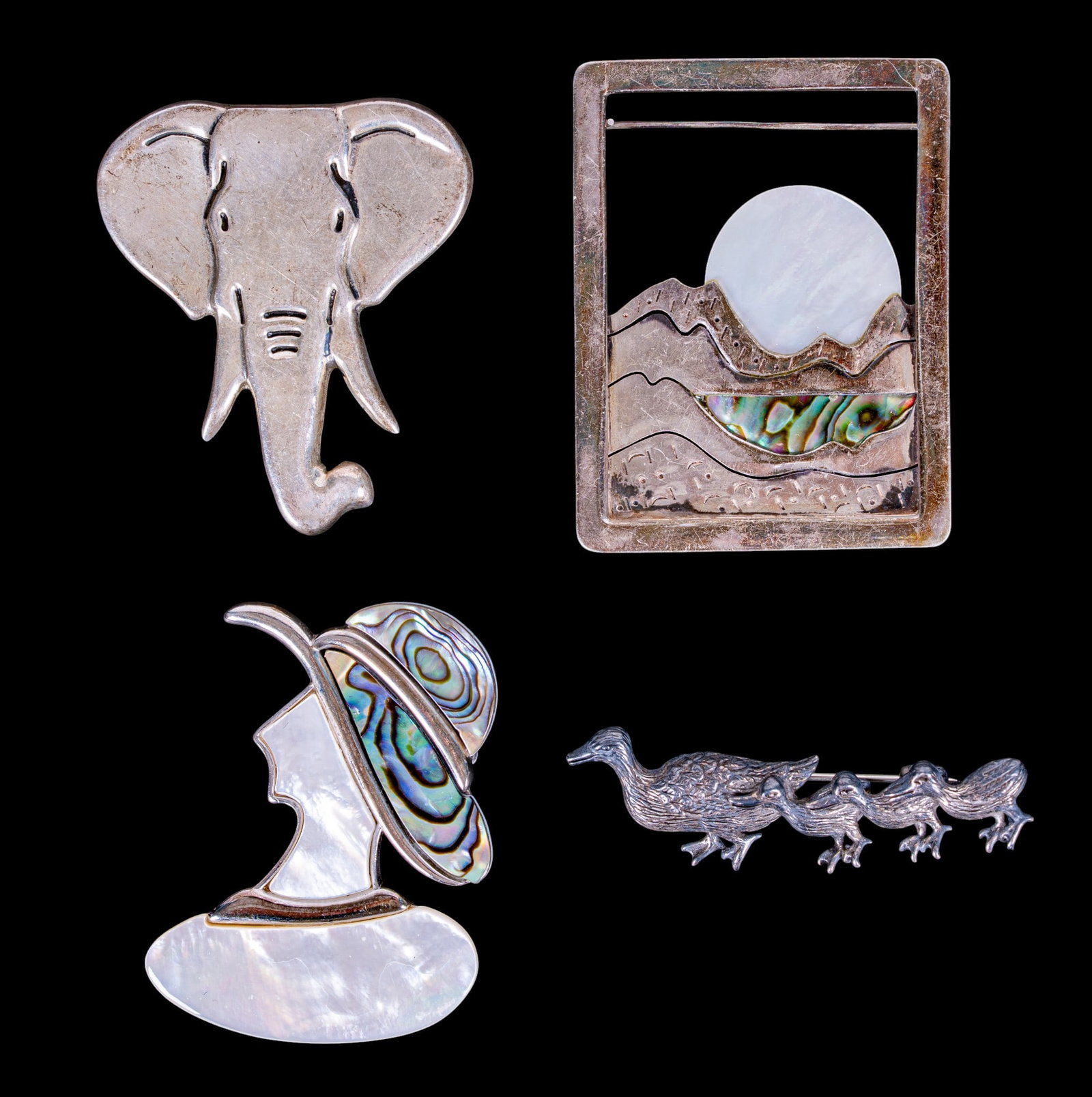 Zelandia & Sterling MOP Brooches: Sterling brooch collection led by a 20.28g Zelandia 925 mother-of-pearl brooch and a 23.45g vintage sterling mother-of-pearl/abalone lady pin, with sterling elephant and artisan 925 duck brooches.