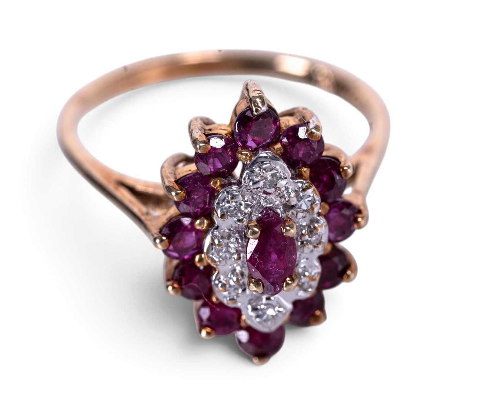 10K Gold Ruby & Diamond Cluster Ring: 10K yellow gold ring set with an oval cut ruby surrounded by round rubies and cluster of round diamonds in a raised basket setting. Interior band marked with 14K and hallmark. Ring size approx. US 6.