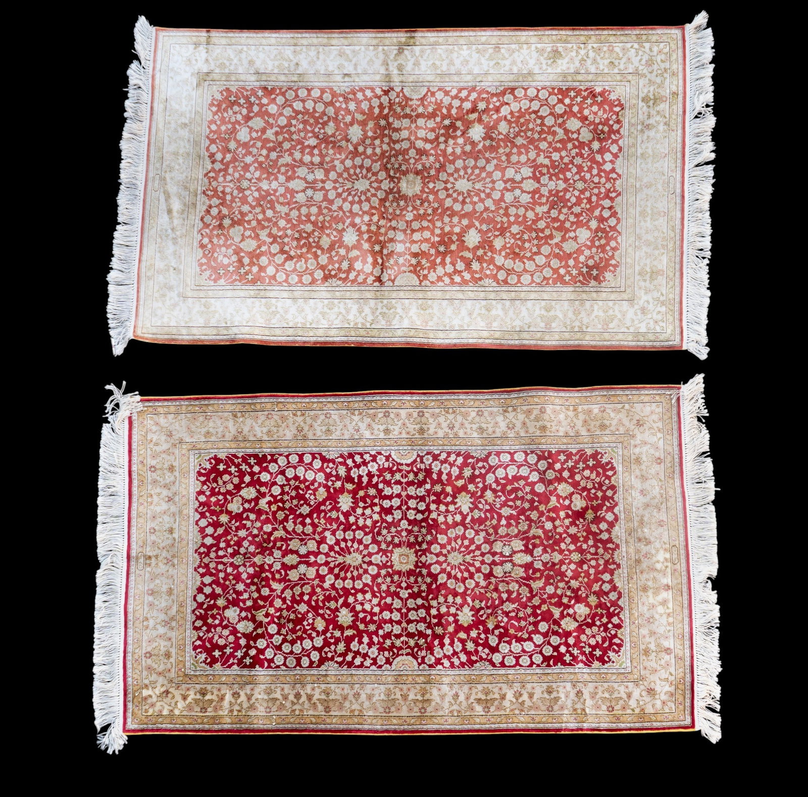 2 Signed Handmade Silk Rugs: Both signed red center, ground scrolling foliate motifs, cream border, one w/ pink center ground. 3'2" x 5'1".