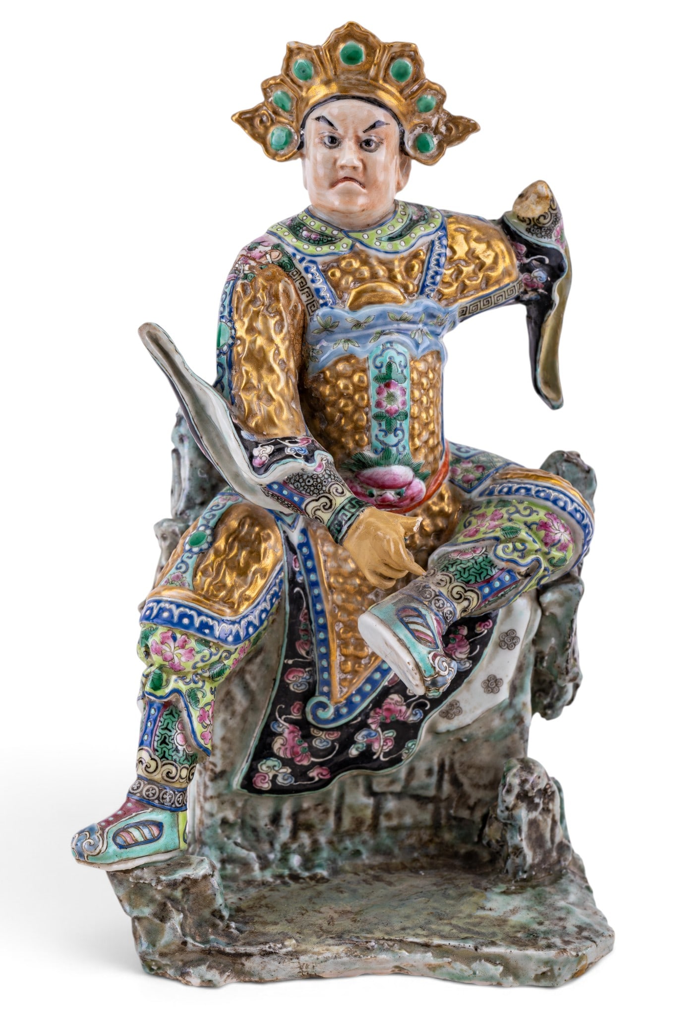 Chinese Famille Rose Porcelain Warrior: Chinese famille rose porcelain figure depicting a seated warrior or guardian dressed in elaborate armor, modeled wearing an ornate headdress. One hand missing, along with thumb to other hand. Drill ho