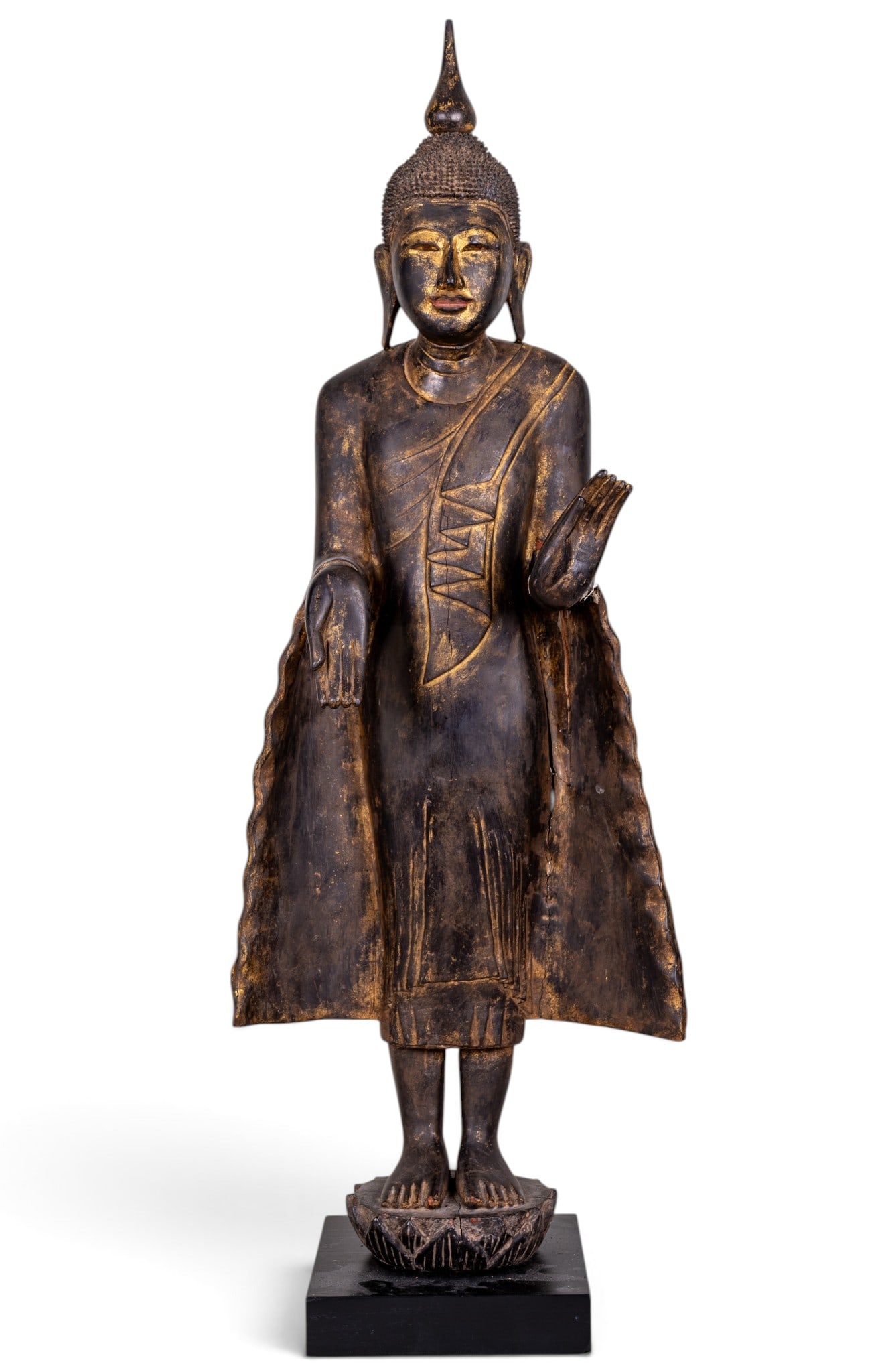 Antique Hand Carved Burmese Buddha Statue: An antique hand carved wood Burmese Buddha statue on a stylized lotus pedestal / black wooden base, note left hand will require restoration, cracks in wood clothing, and faded gold paint. Measures app