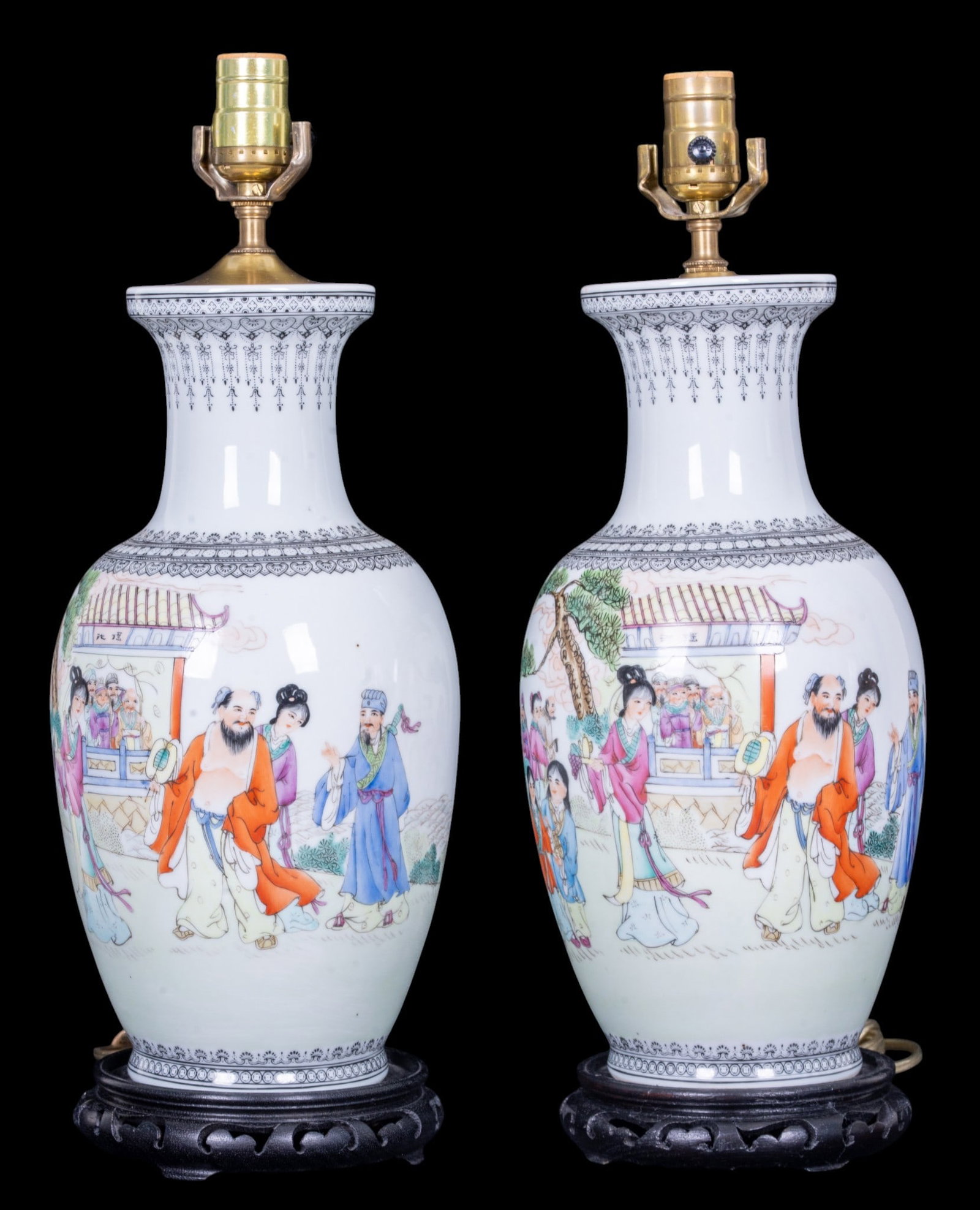 Chinese Porcelain Republic Style Lamps: A pair of vintage Chinese Republic style porcelain vase lamp conversions om carved wood bases, depicting the Immortal Deities, measuring approx. 19" H to the socket. From the Estate of Carol and Georg