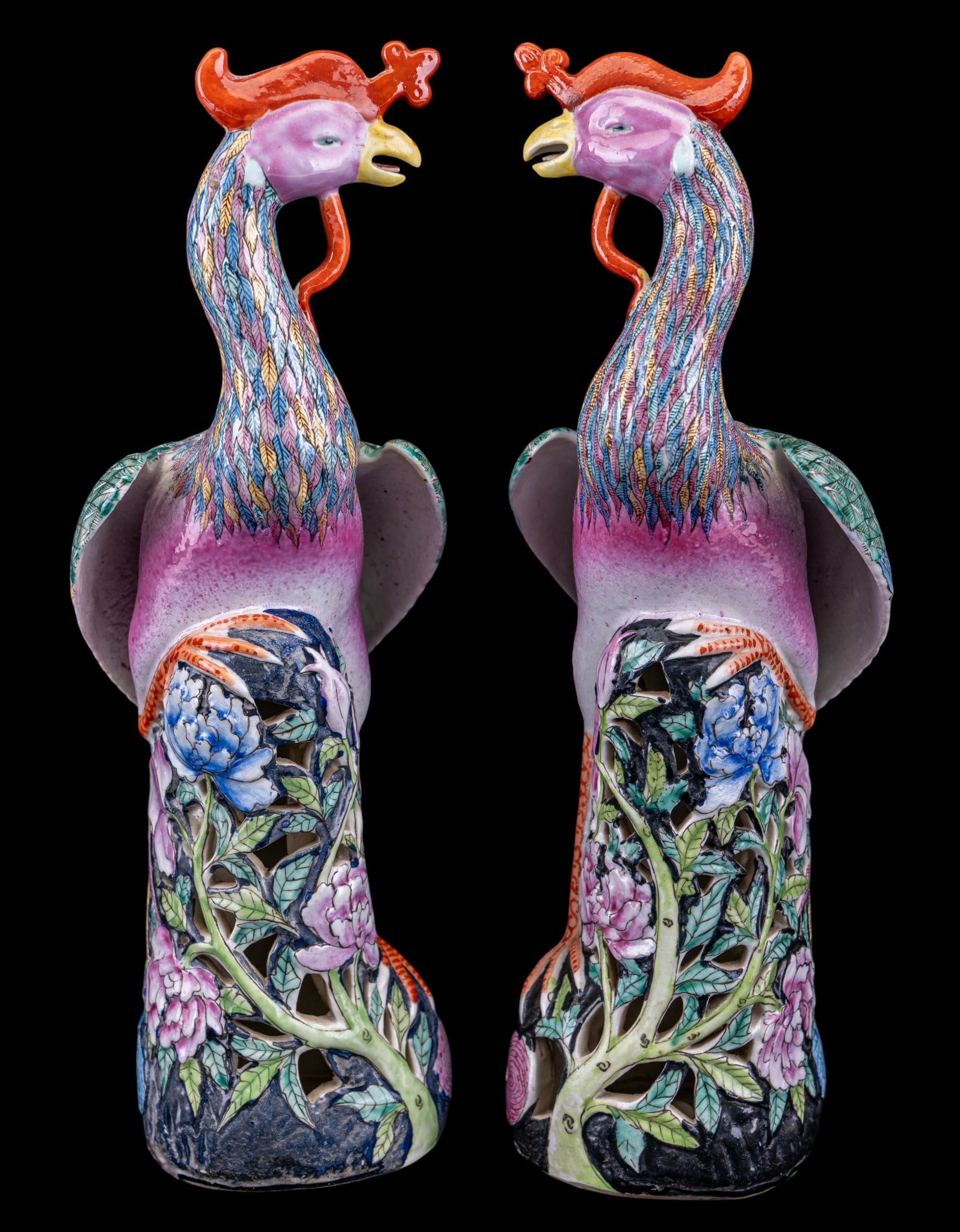Chinese Fenghuang Porcelain Phoenix Statuettes: A pair of hand decorated Chinese porcelain Famille Rose Fenghuang phoenix statuettes, both measure approx. 12" H. Note four character mark on the bottom. From the Estate of Carol and George Thomassy, 