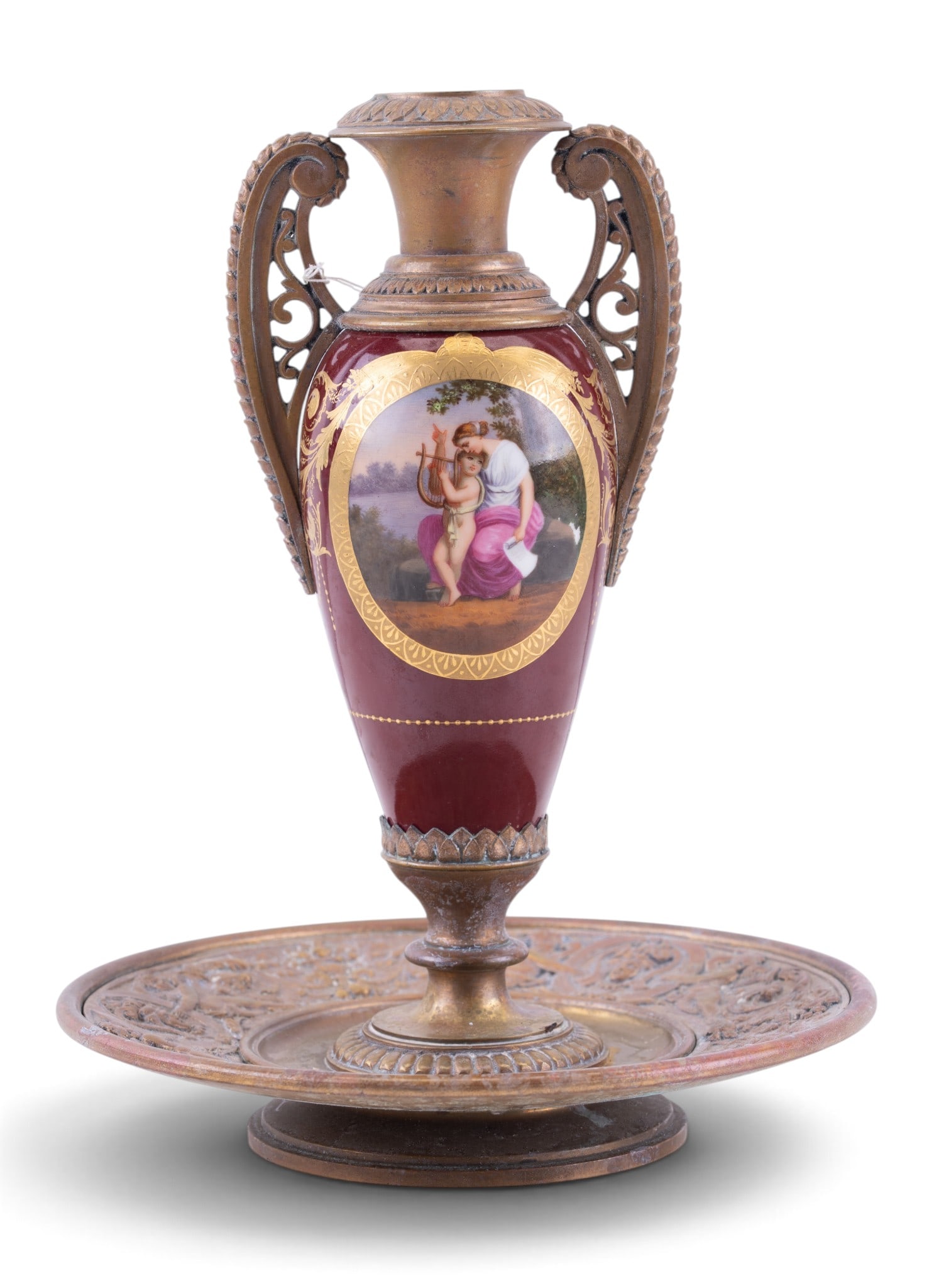 19th C Austrian Bronze & Porcelain Candlestick: A 19th C candlestick featuring a hand painted, double sided porcelain center with ornate bronze handle and base depicting cherubic relief, measures approx. 7" diam x 9" H.
