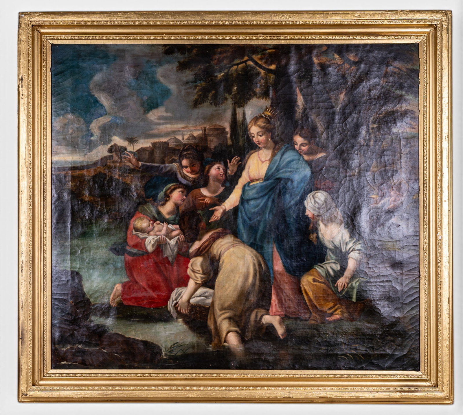 18/19thC Oil on Canvas Painting w/ Gilt Frame: An antique 18/19th C oil on canvas painting featuring a crowned woman with her handmaidens with a baby and basket, including a couple in the bushes behind them, and a city in the far background / simi