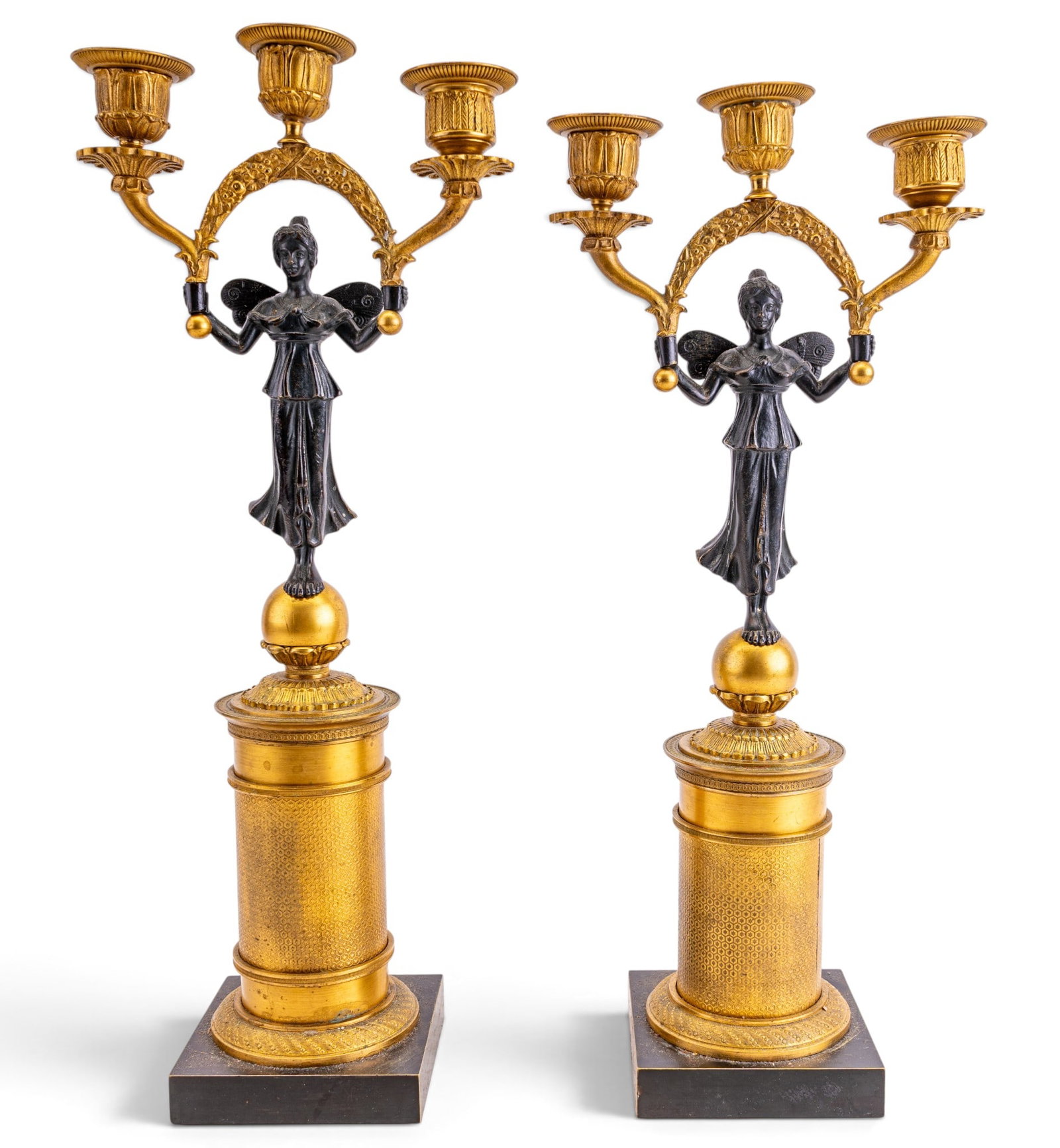 French Empire Figural Gilt 3-Light Candelabra Pair: Pair of French Empire style three-light candelabras. Circa late 19th or early 20th century. Each features beautifully cast, dark-patinated winged figure of Victory (Victoria) balanced atop gilded sphe