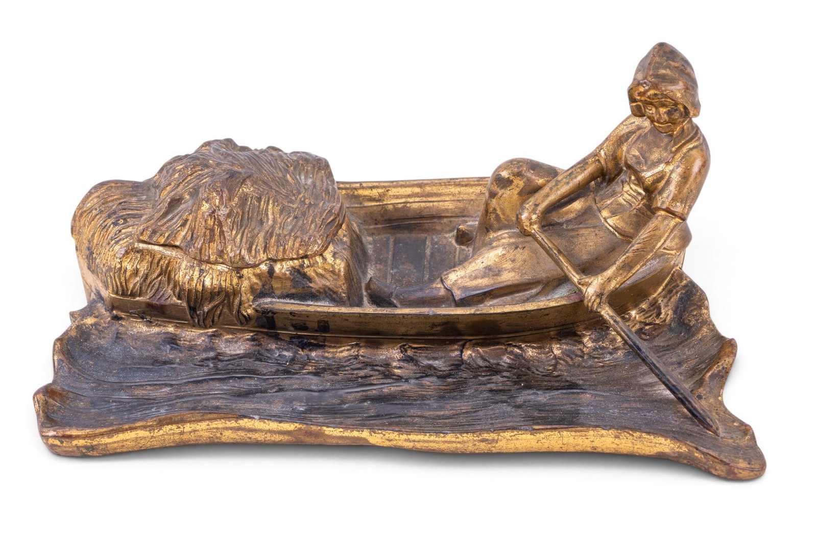 Art Nouveau Figural Inkwell, Dutch Girl: Cast metal inkwell depicting a figure in a boat, with tree trunk textured base and a hinged lid for access to the ink well. Surface shows signs of age-related wear and patina. Ink reservoir his hinge,