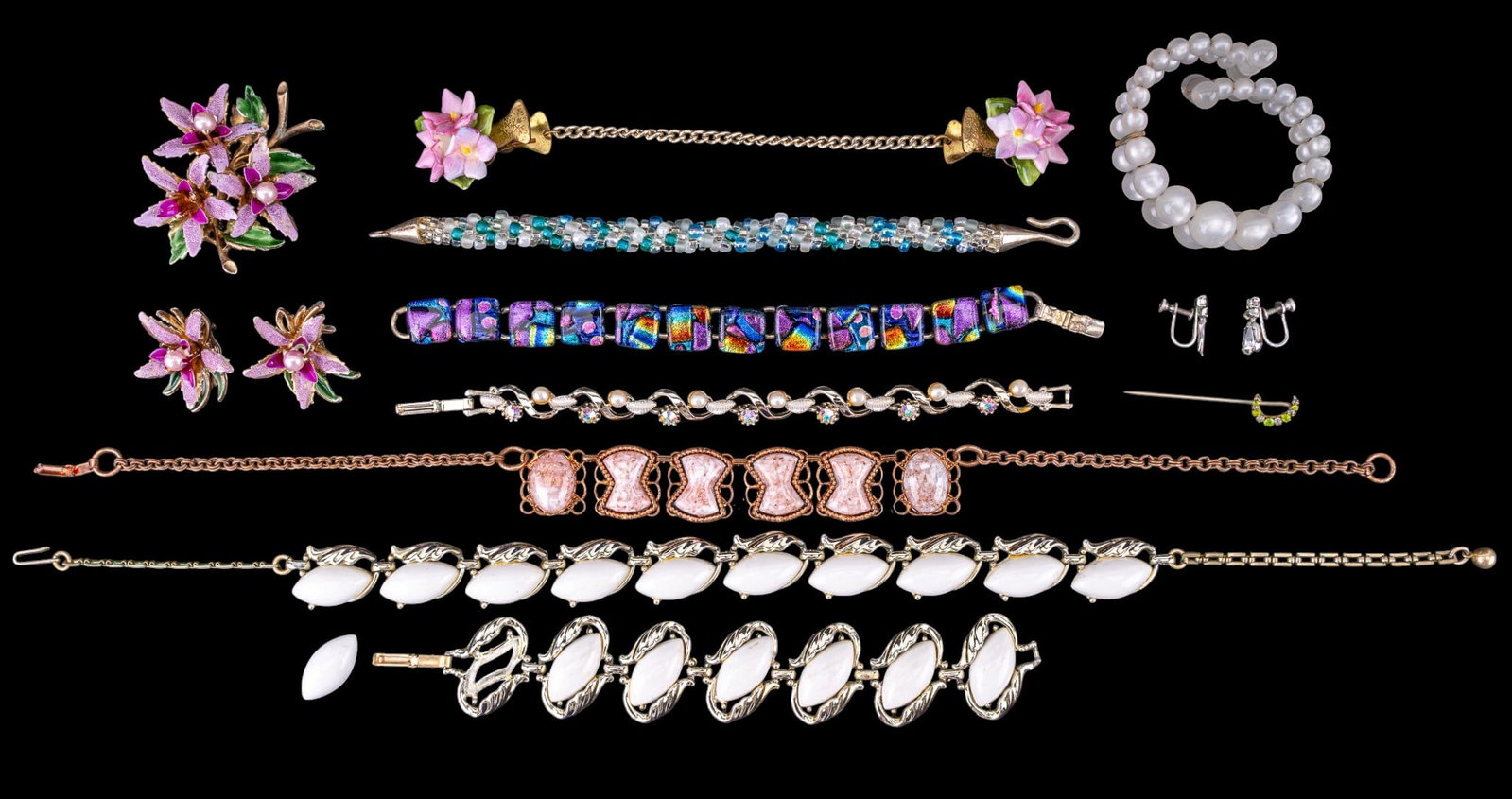 Lucite and Vintage Jewelry: Includes a lucite bracelet, a set of white plastic and metal jewelry, Capodimonte porcelain sweater clip, glass bracelet and floral brooches.